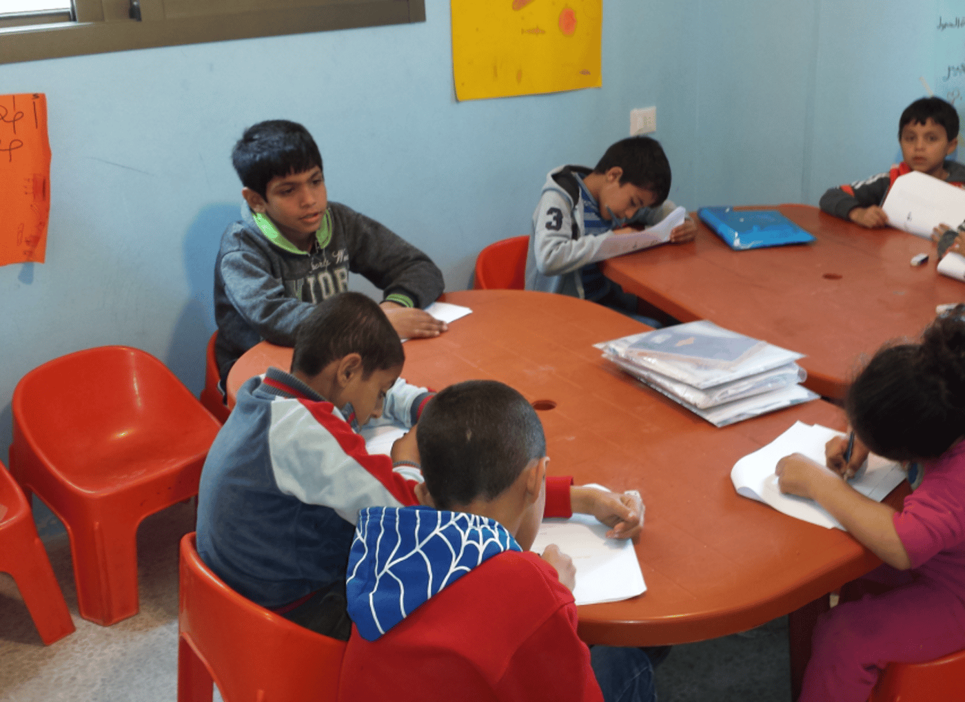 Refugee children in Lebanon keeping up at school
Syrian refugee children avoid dropping out of school with The Norwegian Refugee Council’s (NRC) learning support classes. Kavlifondet’s contribution has made the project possible.
Text: Caroline Graasten Holt
The two brothers Myassar (8) and Ahmad (7) joined the NRC’s learning support project in Bourj al-Shemali in Tyre. The boys were discovered by NRC’s education team while playing in their neighbourhood. They had seen the other children at the learning centre, and were curious about joining. NRC contacted the neighbourhood school, which confirmed that the boys were already registered there. The school principal gave them access to the boys’ results in order for NRC to map their knowledge level.
The boys were offered transport to the learning support course and to their school, to ensure they would get there safely and in time. During the first weeks, Ahmad and Myassar would stand outside the centre’s gates, waiting for it to open. A post-test and feedback from the school principal at the end of the school year have shown that Ahmad and Myassar have improved academically.
Avoid dropping out
In December 2015, a learning support project was established to help refugee children returning to the public school. The main goal was to help refugee children who are struggling to keep up in class, enable them to reach their full potential in school, and give them the opportunity to benefit from their right to free education and avoid dropping out of school.
“The learning support courses contribute to make a difference for refugee children who are meeting more challenges in the Lebanese school system. They need additional support, especially in English, since the children are not used to studying a foreign language,” said Education Specialist in NRC, Marta Schena.
563 children receive support
At the beginning of the project, the children were followed up in the public schools by NRC’s education team. To decide who among the children had the greatest needs for learning support, NRC organised mapping tests based on the Lebanese curriculum. A total of 563 children between 6 and 14 years of age were registered in the project and spread to seven chosen projects areas in the cities Tyre, Saida and Nabatiyeh.
NRC recruited 22 teachers and 10 activity leaders who were all trained by NRC’s education team. These made sure the children good, quality knowledge in Arabic, English, and mathematics. All the children were offered transport to the learning centre, and given school material such as pencils and writing books. Parent groups were established in all project areas to inform and involve the parents about the children’s progress.
Will begin in fourth grade
Lilas (9) has benefitted greatly from being in the NRC programme. The girl is now in thir grade in a public school in Sheeba. When she first started school, it went well, but after a few weeks her mother received a message from the school principal that her daughter had a hard time keeping up with the rest of her class. She risked not being able to complete third grade. Lilas’ family was in a difficult situation economically, and her mother decided to register her in the NRC learning support programme.
Shortly after, Lilas is now doing well and progressing in all three subjects. She is happy to have completed third grade and looks forward to starting in fourth, which she has been confirmed she will do this autumn.
“The children are enthusiastic and obviously excited when they arrive at the NRC learning centre. They feel at home here, that they are accepted,” says Marta Schena.
The learning support classes are running three hours a day, two days a week for three months in all of the seven chosen areas. In March 2016, NRC conducted post tests of all children participating in the programme. Since the first post test conducted in February, 70 percent of the children had done progress in all subjects. This makes it possible for children affected by conflict and the refugee crisis to participate in the Lebanese school system on the same level as other children.
Photo: NRC
