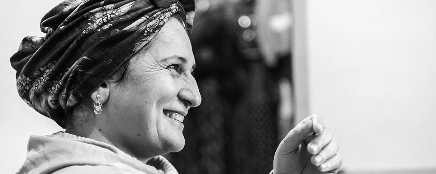 Black and white portrait of a smiling woman.