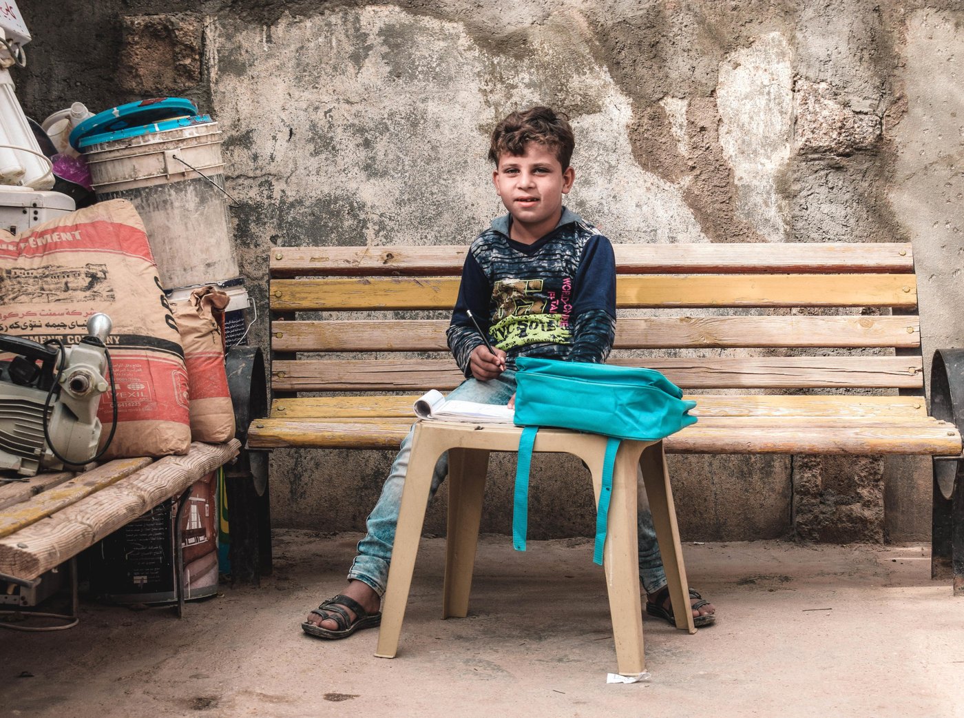 Mohammed; 8 from Al Qa'im; is going back to school for the first time since the retaking of the city from Islamic State group.
Mohammed could not go to school for the past 4 years when Al-Qai'm was under IS rule. His parents wouldn't allow him to go and learn about violence in IS group schools. They were afraid that their child would be brainwashed and join them.
IS group members used to throw Mohmmed to the air and bully him. As a result, Mohammed got traumatized and stayed home all the time. He would go outside the house only accompanied by his parents.
After the retaking of Al-Qa'im, Mohmmed had difficulties overcoming his fears. He was still afraid and used to cry every time his parents would send him to school. When he met NRC education team, they helped him to deal with his trauma and manage his stress.
One of NRC's incentive teachers says: " it was not easy to build trust between Mohammed and us, we had to be patient, sometimes we were visiting and teaching him at home until he got used to us and trusted us".
Mohammed's mother says that without NRC summer courses, Mohammed wouldn't have been able to go back to school and communicate normally with people again. Now after attending NRC summer school, my son loves school and dreams of becoming a doctor in the future".
Photo and Caption by: Helen Baker / NRC