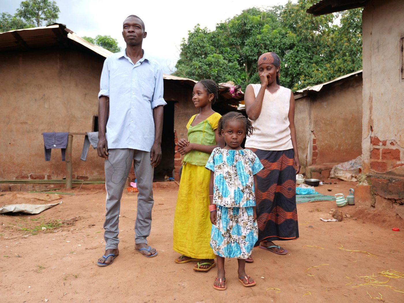 Hamayadi and his wife Roukaya, 37, pose for a photo outside of their house with their two daughters. They also have a third daughter, 11 month old Ashé who was asleed when this photo was taken.