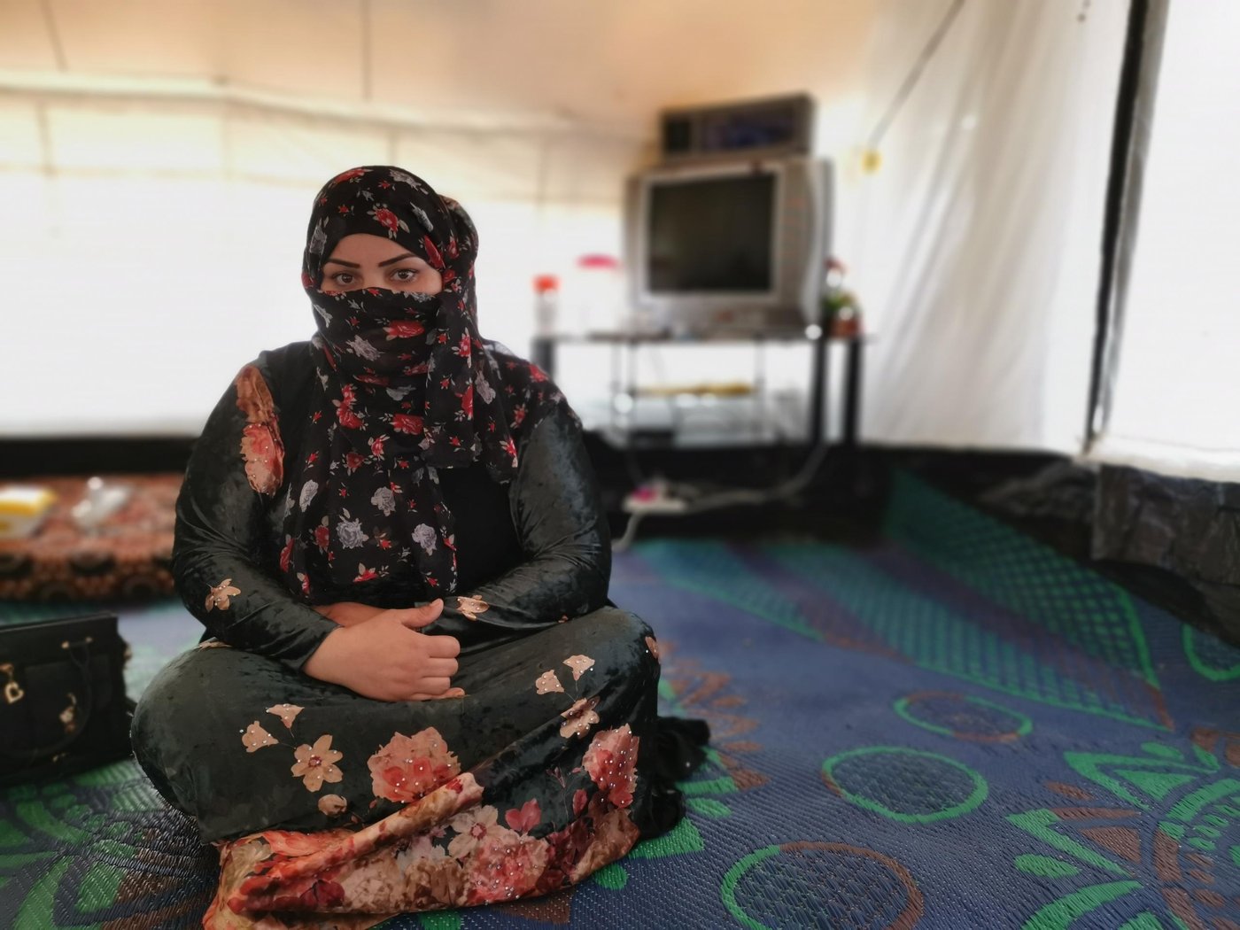 Reem had been displaced since 2017.
“I wish I had a home to return to, but I have nothing. I recently bought a piece of land. In fact, the land I bought belongs to the government. This land was supposed to be used for agriculture purposes, but real estate companies sell it to people and they give us a paper showing that we have paid for this land,” says Reem, 27 from Mosul city, who has been living in a displaced camp since 2017.
Reem worked as a cleaner in the NRC camp management office for a while, and from the money she collected from her work, she bought the land in an agricultural area. This land might be taken by the government at any time.
“I bought one of these lands in an area near Hamam al-Alil because that’s all I could afford,”
Reem is divorced from her husband who owns the house, and she ended up living in the camp.
“The government should help us to find a place to live in or at least give us compensation. We cannot return back to our areas of origin as nothing is left there. I no longer have a house or a family living in that area.”
Photo: Helen Baker / NRC
