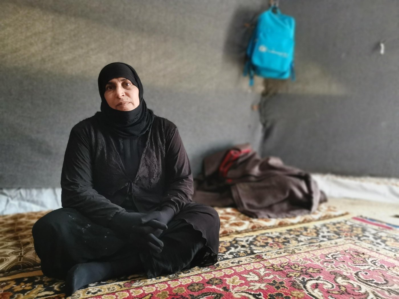 Um Ibrahim – Displaced with six children
“My main issue now is my identity card and those of my children – they’re old. I cannot cross any checkpoint unless I renew identity cards. As my husband is missing, I cannot get new ID cards without his presence or having the original copy of his ID,” Says Um Ibrahim, 44, from Hawija District in Kirkuk Governorate.
Um Ibrahim fled with her six children to a displacement camp during the fight against IS. Her husband who was a farmer and the owner of the land and their house has gone missing. During the fight against the Islamic State group to retake Hawija, he decided to remain on the farm and protect the land and livestock. Later Um Ibrahim received information from the people in the village that her husband had been taken by some militias.
“I am afraid if I go back to our home, whoever took my husband might take my children as well or harm them,” she says.
“My family cannot do anything to help me. They are in the camp just like me. We all are from the same village and none of us can return back to our areas of origin. We are only depending on NGOs for support. The only thing that might help us start our lives again is to renew our IDs and get some compensation to start a small project and get an income to be able to live.”
Photo: Helen Baker/NRC