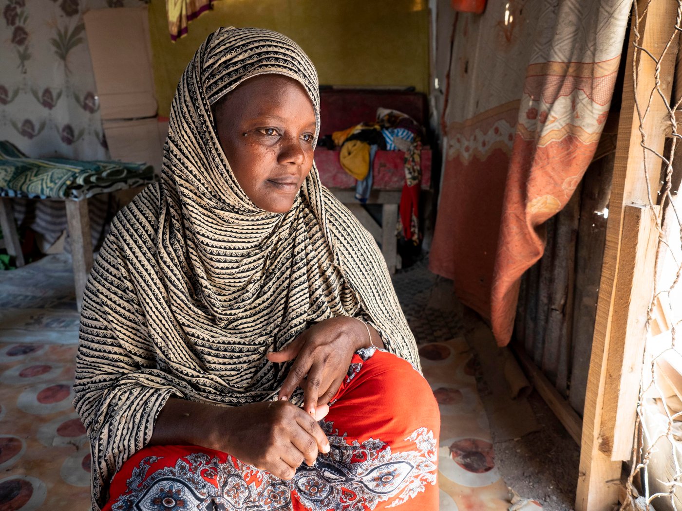 Mariam Farah Hussein, 40, fled from Mogadishu to Bosaso with her husband and seven children a week ago because of violence. They left when their neighbourhood was hit by shelling and managed to escape shortly before their own house was hit and destroyed completely.

The family had friends that had already fled to Bosaso and recommended they do the same. The journey was hard, especially for the children. They travelled for two weeks. In Bosaso they were lucky to be able to share borrow shelter in the camp from their friends. Mariam wants her children to go to school, but has been unable to enrol them as they don't have uniforms. She intends to do everything she can to afford to ensure her children can access education. 

Mariam is currently earning some money working as a cleaner, but it is difficult to get enough work. Her husband has not been able to find a job.

“I lived in constant fear. There were a lot of explosions every day. People were killed every day, murdered – anything could happen. But no-one from my family was killed. Because of this fear we decided to flee.”

“I don’t have school uniforms for my children. If we get support, I want to send my children to school. If we don’t get support, I will pay for them one by one when I have the money.

“When I was there [Mogadishu], I was very afraid. But now I feel safe. Being here is better than there.

“We have seen a lot of problems. When I left my home, it was hit by bombs. I suffered when I was travelling. After I arrived here, I forgot all my problems and fears. I feel safe.”

Children:
Fartuun Abdikadir Mohamed – 15 (green)
Muna Abdikadir Mohamed – 14 (blue/green)
Jijo Abdikadir Mohamed – 13 (brown)
Run Abdikadir Mohamed – 10 (red)
Hassan Abdikadir Mohamed – 9
Zam Zam Abdikadir Mohamed – 3

Photo: Ingrid Prestetun/NRC