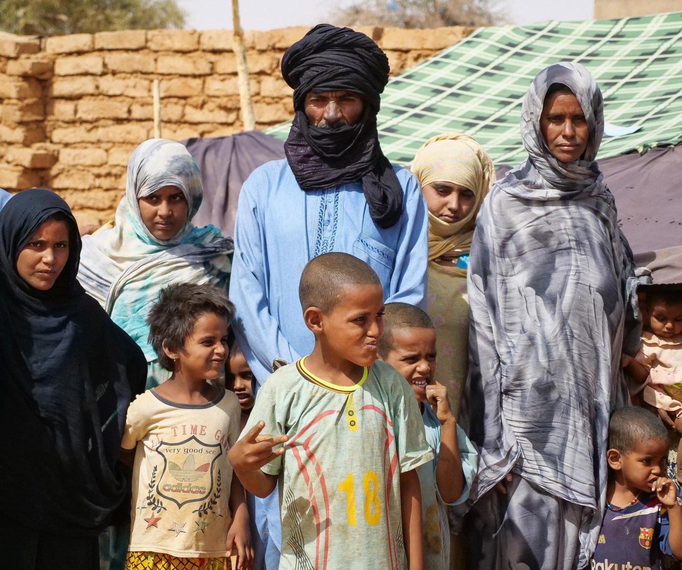 Amadou Ag Baye, 46, poses with his family in a makeshift displacement site in Ménaka, Mali.
“My name is Amadou Ag Baye. It was because of the armed groups in our village that we fled and came here. When we fled, we didn’t take anything with us. When we arrived here, the assistance we received was from our kin from outside the country. We decided to come to Ménaka because we wanted to have security. We also came here so that all the NGOs that are here can know that we are here, and that there are orphans, widows and people who left everything behind amongst us. Since we have arrived here we have had no problems with insecurity, but we are still living in fear. Our most urgent need right now is food. The next need is education for our children, as well as income generating activities for us. We are also in need of water and health services. So we need food, education, health services and income generating activities. Because with the work of our hands we will be able to provide for ourselves. After we have received enough to eat and drink, our next wish is for peace and security.”
Photo: Itunu Kuku/NRC
Date: Tuesday 11 May 2022
Location: Ménaka Mali