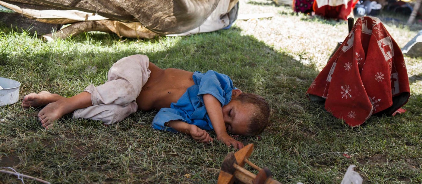 This boy is exhausted and malnourished after his family felt forced to flee their lives as refugees in Pakistan and return to Afghanistan.  He lies underneath a half-collapsed, aging tent. (Photo: NRC/Jim Huylebroek)