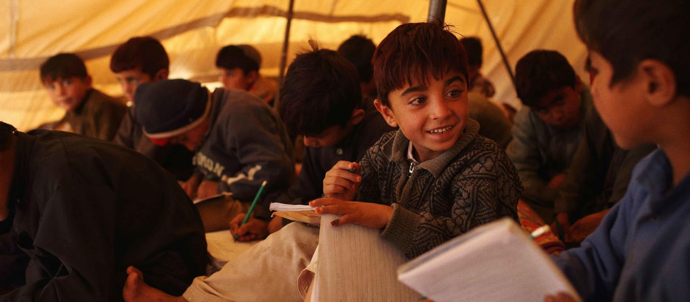 Young boys attend class in temporary tents at the Norwegian Refugee Council (NRC) funded school at Gulan refugee camp in Gurbuz District of Khost Province, Afghanistan. Approximately 3,400 families are now living in the camp after fleeing their homes in North Waziristan in June 2014.

Photo by Andrew Quilty for NRC.