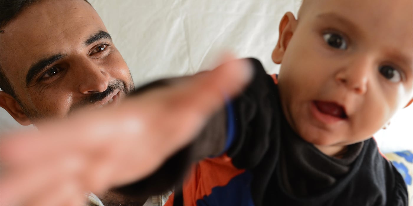Chebli (26) and his child Sidra (7 months). Chebli and his family fled Syria two and a half years ago and they are currently living in a tentted settlement in Northern Lebanon.

Photo: Tiril Skarstein, NRC