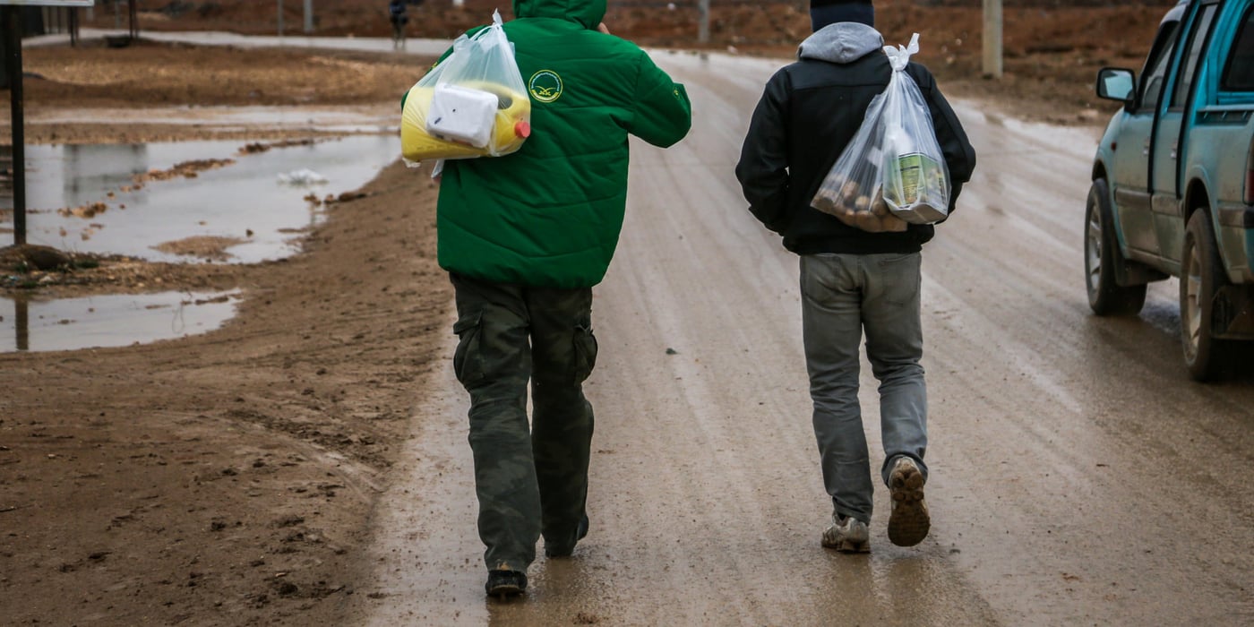 Men heading home with groceries ahead of a predicted rain and snow storm in Zaatari Refugee Camp. 25th January 2016. Photo: NRC/John Cutliffe