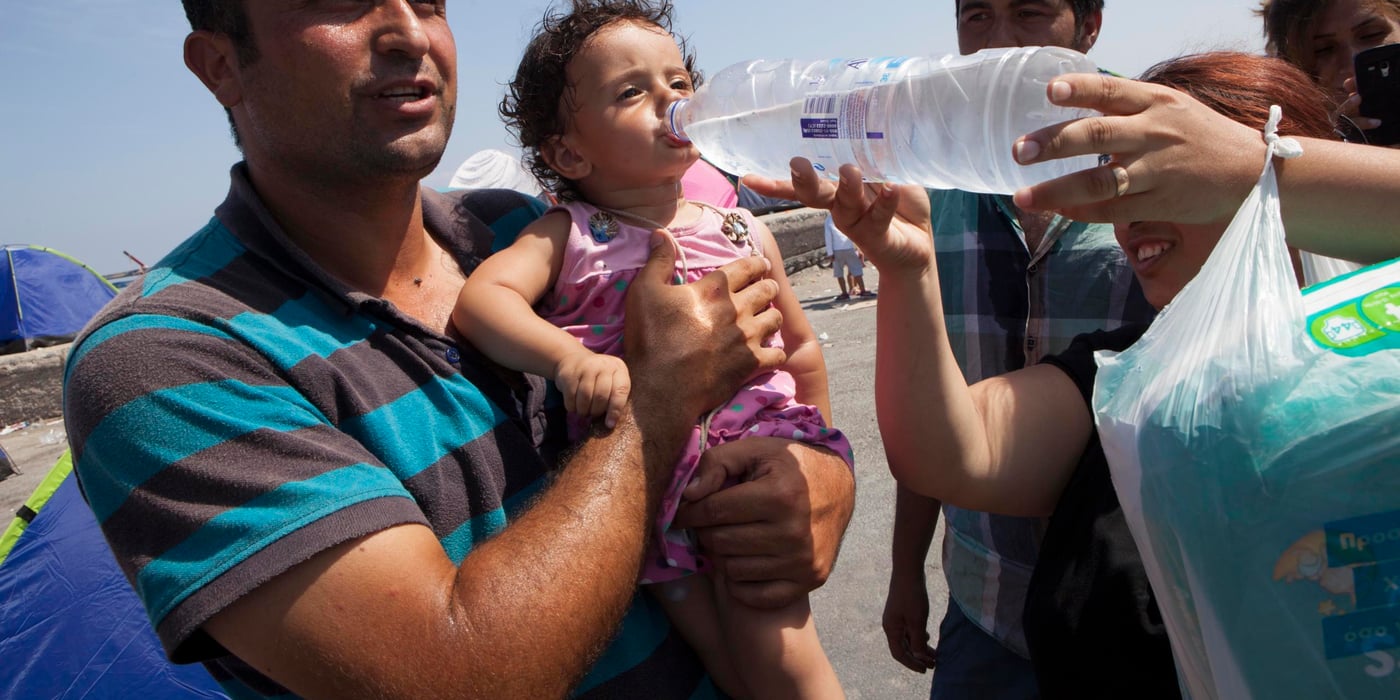 Muhammad Dost Barakat with his one-year-old little girl, Ewa, while she gets a sip of water from Muhammad's wife, Rajin Abdalsalam. They are from Syria, where Muhammad worked as camp manager at a camp for Iraqi refugees. Now he and his family are refugees themselves and would like to come to Norway. (Photo by Raymond Aaserud/NORCAP)