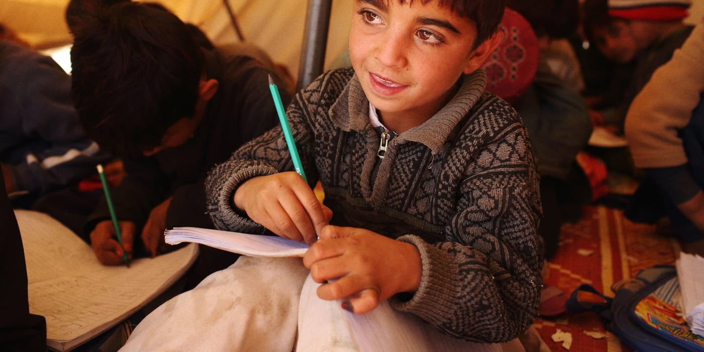 Young boys attend class in temporary tents at the Norwegian Refugee Council (NRC) funded school at Gulan refugee camp in Gurbuz District of Khost Province, Afghanistan. Approximately 3,400 families are now living in the camp after fleeing their homes in North Waziristan when the Pakistani Military mounted an offensive in June, 2014 against militant groups such as the Taliban that use the region as a base to mount attacks from.
Photo: Andrew Quilty / Oculi for Norwegian Refugee Council