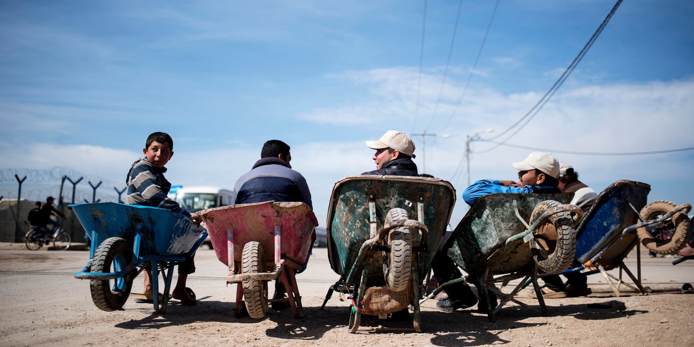 These young boys work on wheelbarrows to help refugees move their objects. They charge 250 fils for light objects and 750 fils for heavier one's. Their workload gets tougher, when visas are issued for syrians to get into the camp.
From left to right: Ahmad, Nasser, and Ragheb
25th February, 2016
Photo: NRC/ Alissa Reznick