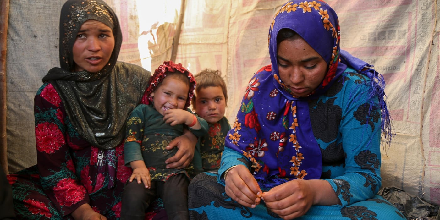 Sultana, 24, (right in blue) and Hajira, 32, (left in dotted red)
Sultana lost her three months daughter due to cold in one of the IDP settlement in Badghis, Afghanistan. The family have forced to come from Kharistan area to Qala-e-naw city due to sever drought some two months ago.
"My little was fine before we left the village. We came here and slept in the open with only a tarpaulin over our head. My daughter got pneumonia at the beginning and latter she died," said her mother grieving.
"She cries all the day and often comes here to talk to me and forget about her daughter," Hajira mother of five said.
"She lost her daughter due to cold and it made me worried not losing my children," she adds.
Hajira has five children and also a seven months pregnant. She asks for immediate shelter and winterization assistance as winter is looming.
"We can't go back to our home because we can't find even a drop water as all wells and water sources have dried up," she said when we asked if they are planning to go back. Though the family do not have proper shelter in Sanjetak settlement, but they have been provided with water tracking and water tanks.
PHoto: NRC/Enayatullah Azad