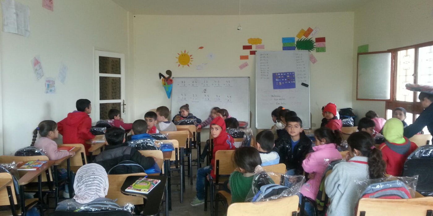 Refugee children in Lebanon keeping up at school
Syrian refugee children avoid dropping out of school with The Norwegian Refugee Council’s (NRC) learning support classes. Kavlifondet’s contribution has made the project possible.
Text: Caroline Graasten Holt
The two brothers Myassar (8) and Ahmad (7) joined the NRC’s learning support project in Bourj al-Shemali in Tyre. The boys were discovered by NRC’s education team while playing in their neighbourhood. They had seen the other children at the learning centre, and were curious about joining. NRC contacted the neighbourhood school, which confirmed that the boys were already registered there. The school principal gave them access to the boys’ results in order for NRC to map their knowledge level.
The boys were offered transport to the learning support course and to their school, to ensure they would get there safely and in time. During the first weeks, Ahmad and Myassar would stand outside the centre’s gates, waiting for it to open. A post-test and feedback from the school principal at the end of the school year have shown that Ahmad and Myassar have improved academically.
Avoid dropping out
In December 2015, a learning support project was established to help refugee children returning to the public school. The main goal was to help refugee children who are struggling to keep up in class, enable them to reach their full potential in school, and give them the opportunity to benefit from their right to free education and avoid dropping out of school.
“The learning support courses contribute to make a difference for refugee children who are meeting more challenges in the Lebanese school system. They need additional support, especially in English, since the children are not used to studying a foreign language,” said Education Specialist in NRC, Marta Schena.
563 children receive support
At the beginning of the project, the children were followed up in the public schools by NRC’s education team. To decide who among the children had the greatest needs for learning support, NRC organised mapping tests based on the Lebanese curriculum. A total of 563 children between 6 and 14 years of age were registered in the project and spread to seven chosen projects areas in the cities Tyre, Saida and Nabatiyeh.
NRC recruited 22 teachers and 10 activity leaders who were all trained by NRC’s education team. These made sure the children good, quality knowledge in Arabic, English, and mathematics. All the children were offered transport to the learning centre, and given school material such as pencils and writing books. Parent groups were established in all project areas to inform and involve the parents about the children’s progress.
Will begin in fourth grade
Lilas (9) has benefitted greatly from being in the NRC programme. The girl is now in thir grade in a public school in Sheeba. When she first started school, it went well, but after a few weeks her mother received a message from the school principal that her daughter had a hard time keeping up with the rest of her class. She risked not being able to complete third grade. Lilas’ family was in a difficult situation economically, and her mother decided to register her in the NRC learning support programme.
Shortly after, Lilas is now doing well and progressing in all three subjects. She is happy to have completed third grade and looks forward to starting in fourth, which she has been confirmed she will do this autumn.
“The children are enthusiastic and obviously excited when they arrive at the NRC learning centre. They feel at home here, that they are accepted,” says Marta Schena.
The learning support classes are running three hours a day, two days a week for three months in all of the seven chosen areas. In March 2016, NRC conducted post tests of all children participating in the programme. Since the first post test conducted in February, 70 percent of the children had done progress in all subjects. This makes it possible for children affected by conflict and the refugee crisis to participate in the Lebanese school system on the same level as other children.
Photo: NRC