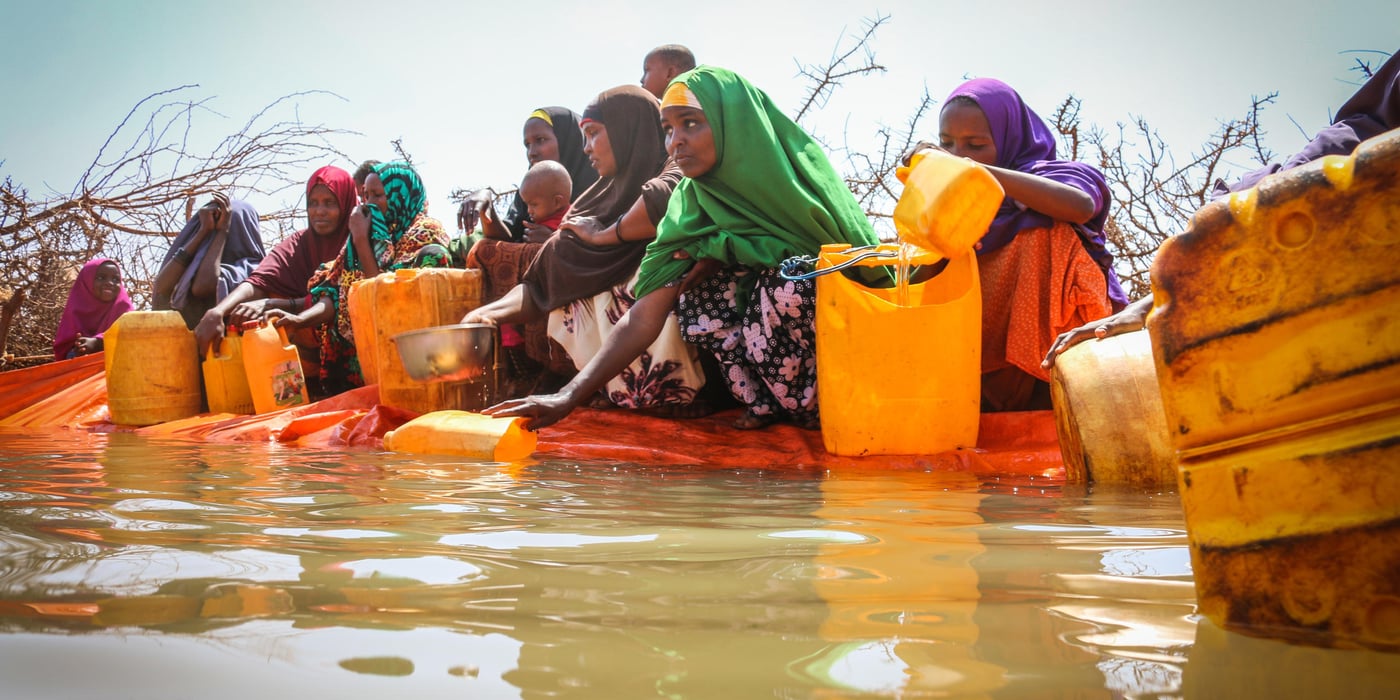 Women collect water, as NRC is providing water throught water trucking activities in the Dollow District of Somalia. The water is helping IDPs and host communities to counter the harsh effects of the drought as a short term measure. Photo: NRC/Nashon Tado