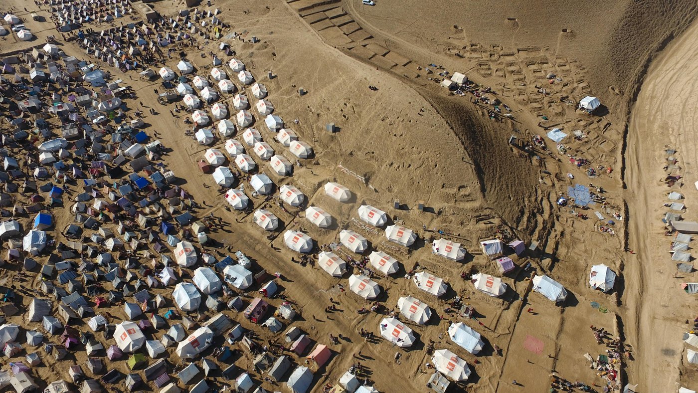 This drone footage shows the size and scale of displaced family tents in one of the IDP settlement in Badghis. There are thousands of makeshift homes spread between mountain hills on the outskirt of Qala-i-naw city.
An estimated 150 thousand families from rural areas of Badghis have left their homes for Qala-i-naw as the ongoing drought and climate change struck their villages. As of November, a total of 340,406 people have been affected by natural disasters throughout Afghanistan and out of that, 158,000 have been displaced only in Badghis province.
Drought isn’t the only challenge that these families are fronting in the region; the deteriorating prolonged security situation has also added to their miseries. Many families can’t return to their homes fearing Taliban harassment and forced recruitment. The harsh winter conditions are a major challenge for the displaced families.
The families are living in seven different collective sites hoping to get humanitarian assistance. Many INGOs, including NRC and the UN bodies are involved in responding to the families. Based on UN OCHA, the first batch of 15,000 tents were delivered to Herat on 24 November. The distribution of tents in Badghis and Herat is underway by NRC and other NGOs for those who are in need of shelter. There will also be NFIs distribution for 10,000 households in both Herat and Badghis.
Photo: NRC/Enayatullah Azad