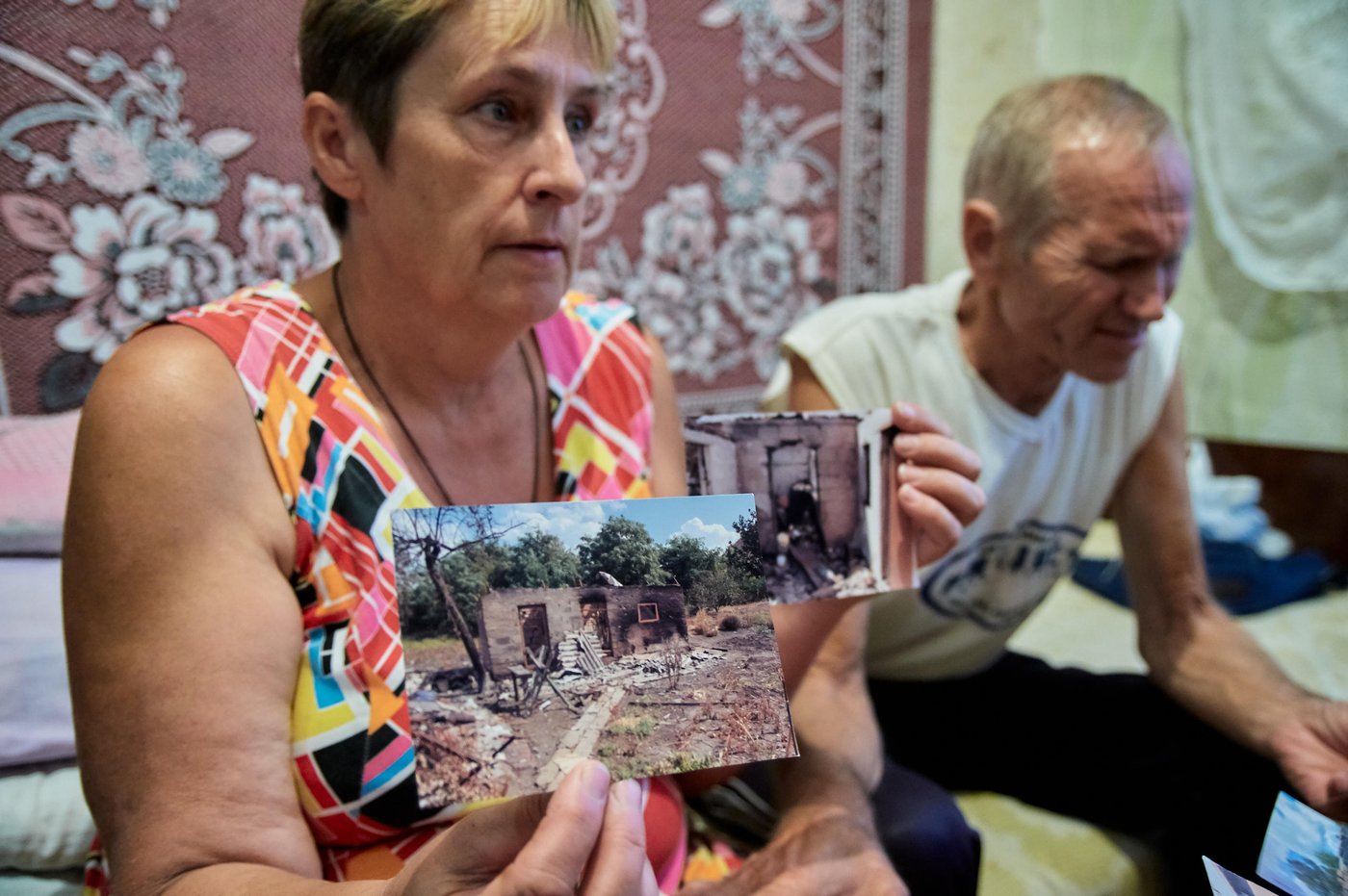 Nadiia Parfemchuk, 54, and Heorhii Mironenko, 61 live in Kurakhove collective centre more than five years without bleak prospects to return home in Marinka, as it is destroyed and located in mine-contaminated area with everyday shelling.
“We lived in a big fully refurbished house in Marinka and had everything what we needed for normal life. We have been living here since August 2014, it was impossible to stay home, as it became epicentre for hostilities. When our house was hit, we were in Kurakhove with my husband’s sister. Everything was burnt. Nothing remained there, we were trying to get our staff, but could not do it, because of active hostilities. We came here in what we were wearing. Local town residents and humanitarian organisations helped us a lot. My daughters live here in Kurakhove one in collective centre, another one rents an apartment”, says Nadiia.
Nadiia was working in the kindergarten, however, she got under reduction and lost her job. She did not reach retirement age and barely makes the ends meet. Their house is destroyed, and they have to pay 2,000 hryvnias (nearly 70 US dollars) for utilities in cold season. It is very mouldy here.
Heorhii started working recently, as they need to survive somehow. Most of humanitarian assistance is provided to pensioners over 65 years. Their house is in the red zone, they cannot even access it. Even military people do not walk there. Nadiia and Heorhii say that they would like to get house somewhere in the safe place.
Photo: Dmytro Telushkin/the Norwegian Refugee Council