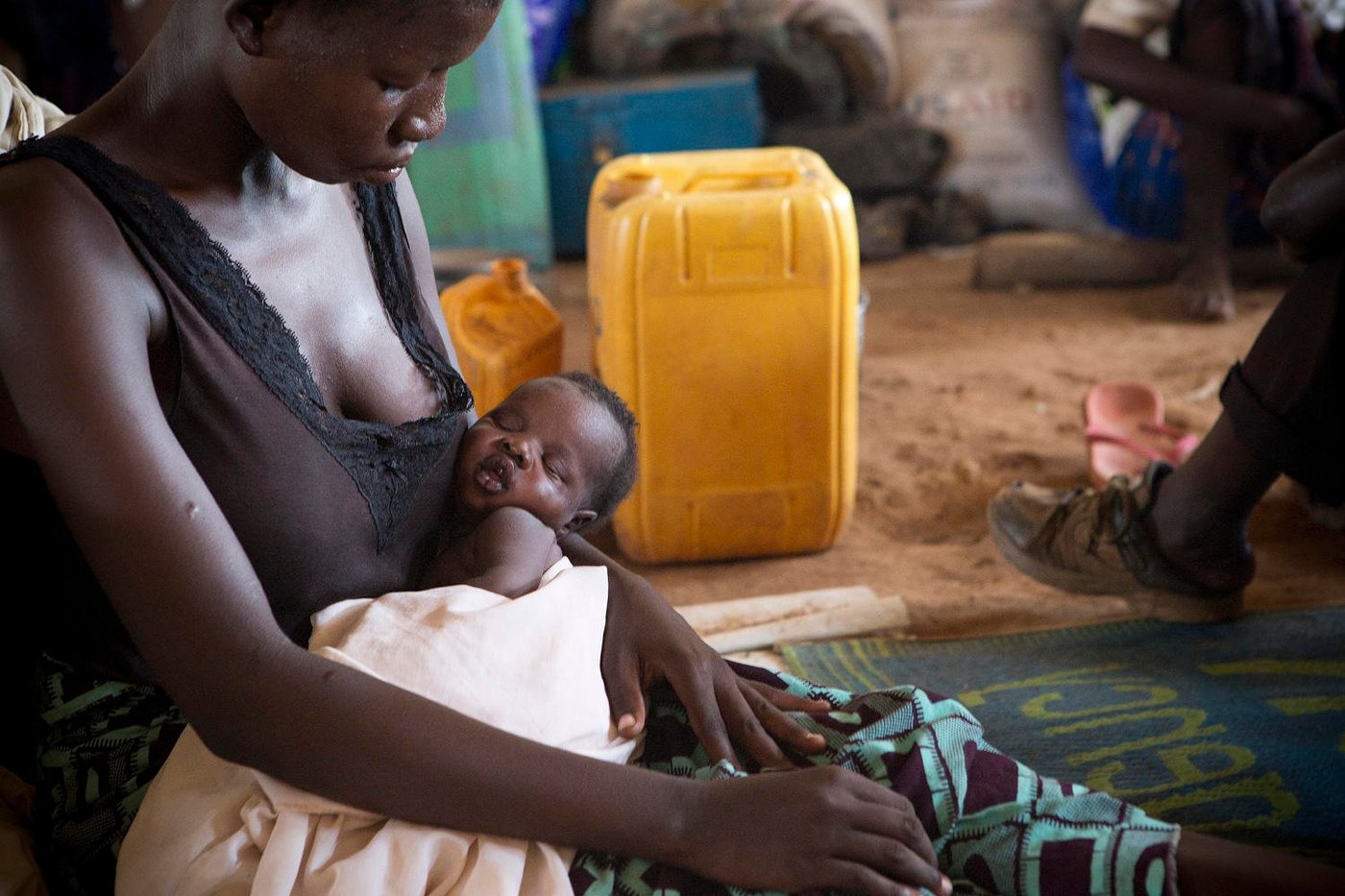 Alice Digama (24) is sitting on the tent floor with her two-week-old baby. Her son is one of many children born a refugee. The new-born is breathing heavily. It is blazing hot inside the tent. Digama was heavily pregnant when she escaped and crossed the border, after her husband left her for an-other wife. Now she dreams of a peaceful life and a secure future for her son.
“I'm so tired of the war. I cannot stand to be afraid anymore. Now, I think about my boy's future. I hope he will be fine,” says Digama.
While the number of refugees in South Sudan’s neighbouring country Uganda is increasing, the war continues to ravage the world's youngest country.
------
Thousands fleeing to northern Uganda
The deadly fighting in South Sudan has created enormous challenges for neighbouring Uganda. From food shortage to water-borne diseases, the humanitarian needs are greater than ever before.
Text and photo: Sofi Lundin
“We ran for our lives to avoid being killed. I spent all the money I had to bring my children to safety in Uganda,” says Agnes Drabua (35). She is one among thousands of refugees who crossed the border into neighbouring Uganda last month.
According to the latest figures from the UN Refugee Agency (UNHCR), 69,215 South Sudanese refugees have crossed into Uganda since the recent fighting erupted on 7 July. That is more than twice the number of people who came during the year’s first six months. Reception centres can no longer cope with the extraordinary influx of refugees. Humanitarian organisations and the authori-ties are doing everything they can to meet the needs, but they lack resources.
“The large number of refugees has put enormous pressure on our resources. We do everything we can to assist, so that the aid reaches those in need, but it is extremely challenging. We do not have enough staff and the economic resources are too scarce to cover all the needs,” says Emmanuel Adowa who works at the NRC office in Adjumani.
Reducing food rations
The open square by the Nyumanzi reception centre is crowded. The reception centre, which is de-signed to accommodate around 2,000 refugees, is today home to more than 13,000 South Suda-nese refugees.
“The centre is overflowing and we can no longer provide enough food to people residing here. In August, we have been forced to reduce food distributions by half to those who are already resi-dents, in order to be able to help the new arrivals,” says Albert Alumbi, settlement coordinator at the government office in Nyumanzi.
Cholera outbreak
About 90 percent of all South Sudanese refugees in Uganda are women and children. Agnes Drabua (35) sits together with her five children in the newly opened settlement Pagirinya. As the majority of women here, she came alone with her children across the border.
“We are peaceful people. I only want peace and a safe future for my children,” says Drabua.
The Pagrinya settlement is only a few weeks old, but already home to over 27,000 people. A chol-era outbreak few days ago has put even greater pressure on resources in the area.
“At first, we identified two patients with cholera. Now, the figures have risen to 37 people and the cholera team in the area is working hard to stop it from spreading,” said Ahmed Rasul, health worker at the clinic in Pagrinya.
“We have been forced to establish strict procedures for hygiene. The big challenge is that the set-tlement is full. We are deploying people from here to the newest settlement in Yumbe, says Vincent Amaroma, settlement assistant at the government office in Pagrinya.
Food crisis
South Sudan is today one of the world's largest humanitarian crises. According to UNHCR, close to a million refugees have crossed the border into neighbouring Sudan, Uganda, Ethiopia and Kenya. Inside the country, nearly two million people are displaced. The refugees coming across the border tell of brutal killings, rebels burning down houses, and military stealing peoples’ money. At the border in Elegu, the last days have been less hectic, but the steady stream of refugees continues to pass. Although the conflicts in South Sudan have subsided since the battles broke out in early July, the situation is still tense.
“Yesterday, several police officers came across the border with their families. This says something about the security situation in the country. Now that the fighting has calmed down, one of the main reasons why people flee is food shortage. We still have room for more, but it will not last for long,” says Frida Kajoki, registration officer at Elegu.
Born a refugee
Alice Digama (24) is sitting on the tent floor with her two-week-old baby. Her son is one of many children born a refugee. The new-born is breathing heavily. It is blazing hot inside the tent. Digama was heavily pregnant when she escaped and crossed the border, after her husband left her for an-other wife. Now she dreams of a peaceful life and a secure future for her son.
“I'm so tired of the war. I cannot stand to be afraid anymore. Now, I think about my boy's future. I hope he will be fine,” says Digama.
While the number of refugees in South Sudan’s neighbouring country Uganda is increasing, the war continues to ravage the world's youngest country.
Text og photo: NRC/Sofi Lundin