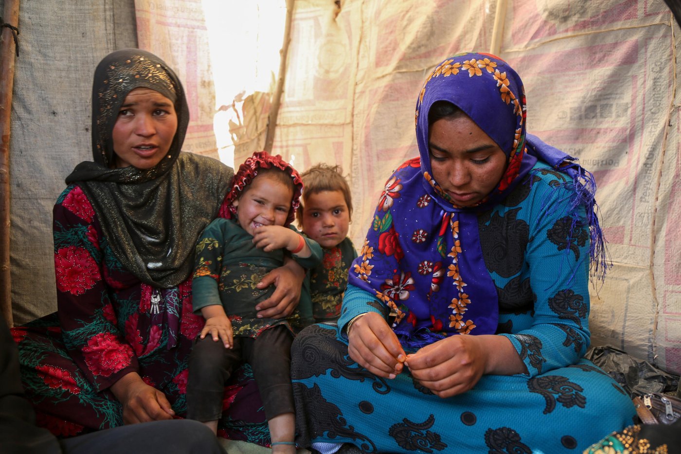 Sultana, 24, (right in blue) and Hajira, 32, (left in dotted red)
Sultana lost her three months daughter due to cold in one of the IDP settlement in Badghis, Afghanistan. The family have forced to come from Kharistan area to Qala-e-naw city due to sever drought some two months ago.
"My little was fine before we left the village. We came here and slept in the open with only a tarpaulin over our head. My daughter got pneumonia at the beginning and latter she died," said her mother grieving.
"She cries all the day and often comes here to talk to me and forget about her daughter," Hajira mother of five said.
"She lost her daughter due to cold and it made me worried not losing my children," she adds.
Hajira has five children and also a seven months pregnant. She asks for immediate shelter and winterization assistance as winter is looming.
"We can't go back to our home because we can't find even a drop water as all wells and water sources have dried up," she said when we asked if they are planning to go back. Though the family do not have proper shelter in Sanjetak settlement, but they have been provided with water tracking and water tanks.
PHoto: NRC/Enayatullah Azad