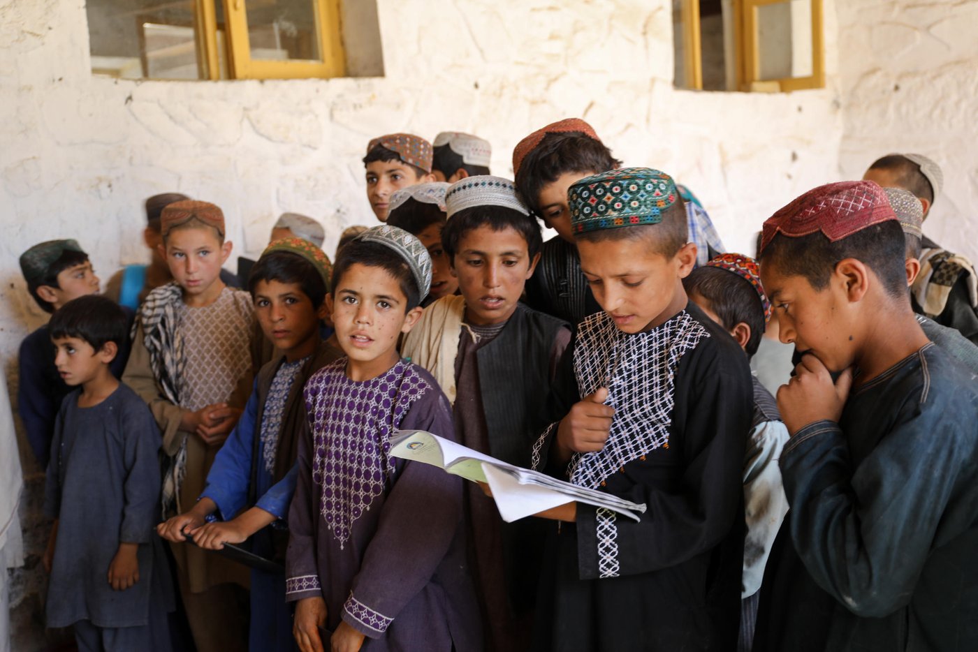 This is Charamgar secondary school some 5KM on the northern side of Trinkot, Uruzgan Province. This school was occupied and used as a checkpoint by the Taliban for almost six months in 2015/16, but the school remain shut for whole academic year. When the the Taliban were moved back and school resumed again, all the roofing, boundary walls and gates were either destroyed or was stolen.
NRC stepped forward and started doing some basic security upgrading to this and some three other schools in and around Trin Kot. The work includes; Iron sheets for the roofing of schools, installing emergency gates, main gates, building boundaries walls, grill work, windows repairing, glasses and blast films for the windows. NRC also established a schools-based Protection Committee (SBPCs) for each school with support and participation of PED, Community shura.
The school activities are closely monitored and checked by the community people, PED and the community has also been accountable to protect the schools from future expected incidents and they are also encouraging the families to get their children to school.
Repairing work and studies continues in this school and currently around 15 staff are teaching some 600 students in two different shifts.
“We feel more safe and secure now after building the boundary walls and installing the gates. Now, we have bigger yard and students can play inside the school building. The boundary is also keeping safe from any attack and flying bullets,” said Nida Mohammad, the Chramgar school principle.
Photo: NRC/Enayatullah Azad