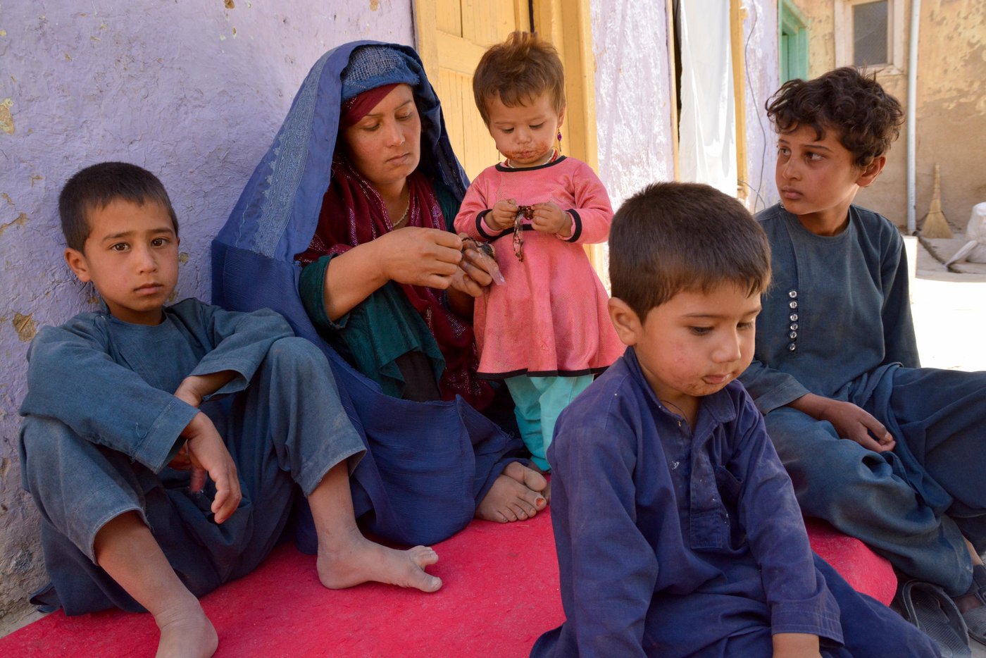 Gul Hussian’s sister-in-law Adila, 37, and her four children was among 235 women and children that was abducted by the Taliban militants.

Adila and her husband, sayed hassan, tied the children on back of family donkey and tried to escape from the village, when the Taliban advanced further in the village. They walked in the dark for almost two hours.  But the armed militants cut off their route in the valley, stopping them from reaching safety in the provincial capital.

“When the armed [militants] blocked us, my husband stood by us. He didn’t leave. My brother-in-law escaped and requested him, but he couldn’t leave us.”
The Taliban militants took Adila’s husband and his 13-year-old son, Kumail. He left her son later and killed her husband.

“His hands were tied on the back. The Taliban was pushing him forward and he was turning his head back seeing us. Wish he escaped; he would be alive now,” Said Adila. And now, Adila has to take care of three son a daughter alone.

 “My father pledged Taliban commander to release me, he let me join women” said Adila’s son Kumail.

Kumail was terrified and can’t sleep properly now, said his mother.
Photo: NRC/Enayatullah Azad