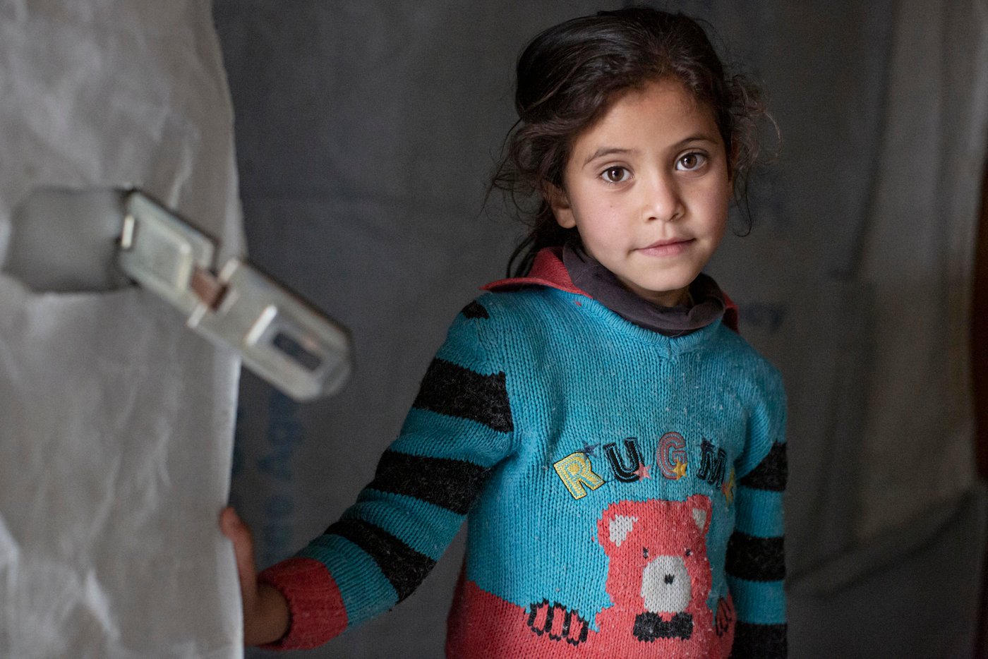 Her family fled their home in Qusayr, Syria, in 2011, when their home was bombed. The Norwegian Refugee Council helped the family by installing cupboards and supplying material to cover and reinforce their tent, as well as installing and maintaining toilets in their settlement and supplying drinking water.
Photo: Sam Tarling/NRC