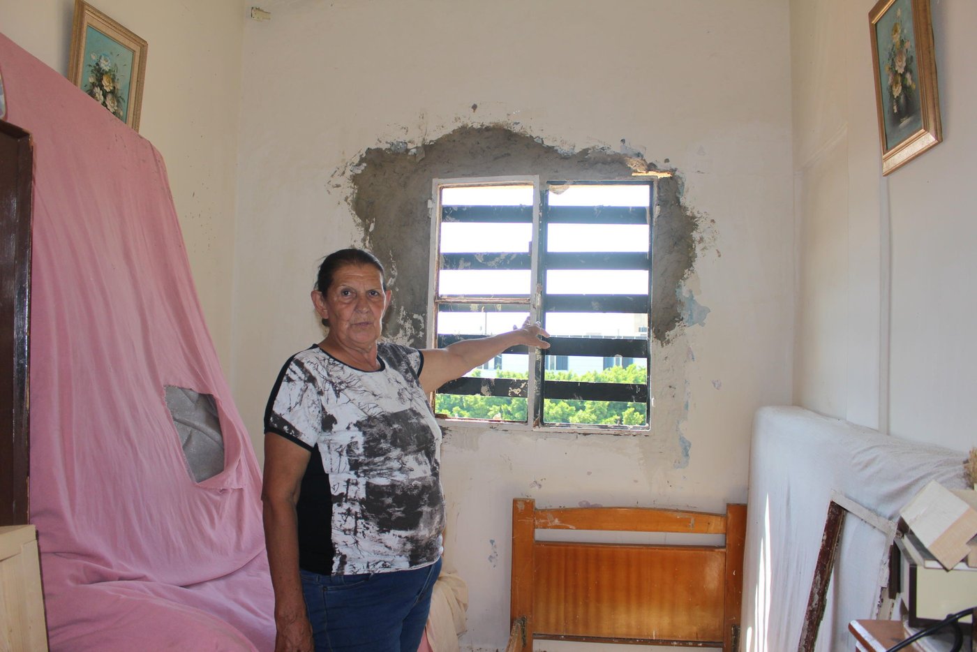 The glass of all the windows were shatterd in Hayat's home in Karantina, one of the most affected areas by the Beirut explosion.

Hayat, 70, is one of thousands of people who were affected by the blast that damaged parts of their homes. She and her two sons with their families live in Karantina, XX km away from the explosion site. They live on different floors in the same three store-building. At the time of the explosion, she was sitting outside on terrace of the building’s rooftop. 

“I was sitting on our terrace when the first explosion happened. I thought that airplanes were bombing,” says Hayat. “I immediately ran inside to get some of my key documents and my purse when the second explosion happened. It was so loud and it blew me off the ground.” 

“I didn’t know what to do and my first thought was that my sons could not have survived this. Then, I saw my son, Giofar, coming up the stairs calling for me in panic to check if I was okay. The blood was dripping from his head and his body was full of glass shatter,” says Hayat. 

“We have lived in this building for 27 years. I have witnessed all the wars and conflicts in Beirut but never have I seen Beirut so severely damaged as this,” says Hayat. “The scene outside our home looked like a battle field, beyond what you can comprehend. People were running around in panic, bodies on the ground, blood everywhere, buildings falling apart, cars under the rubble and glass shatter all over,” she says.  

“There is a hospital opposite to where we live but it was totally destroyed and we were not able to move to take my son to the hospital. We lost him in the turmoil but a police officer had seen him injured and took him on his Vespa to a hospital about 15 km from where we live,” Hayat explains. “He came back fully stitched but we are lucky he survived,” she says. 

“My other son’s wife was giving birth a few hours before the explosion, she delivered a baby boy. The hospital had to release her after just a few hours just to make space to other people who were heavily injured in the blast,” says Hayat. 

“My grandchildren are all traumatized. They are afraid and can’t sleep during the night. Whenever they hear any loud sound they start screaming and fear another explosion will go off. We are constantly worried that something else will happen,” she says.

“We have a lot of needs now, the windows, curtains, and furniture are all damaged. The glass shatters destroyed everything and the walls have fallen down. My kitchen is not functioning and the water pipes are all broken. We need our homes to be repaired urgently but we can’t afford the repairs,” Hayat says. “We don’t know when we will get assistance but we need everyone’s help to rebuild the streets of Beirut,” she says.  

“When I look at the destruction around us, I can only say we were saved by a miracle,” says Hayat. “In the end all the material damage can be replaced, we can eventually buy new ones but a life can’t be replaced,” she says. 

“Imagine, one of the neighbours in the building next to ours is Syrian. He has been living alone for a while and his family in Syria. A few weeks ago, the situation where his wife and two daughters live in Syria worsened so he brought them here to be in safety and escape the war. But they didn’t escape death, the roof fell over them in the explosion and his wife and two daughters died. If you see him now, it’s like he has gone mad,” she says. 

“My husband died when my children were very young and I raised them as a single mother. I put all my heart and effort to raise them and keep them safe. My biggest fear is to lose them now when they are adults. They are my whole life and if something happens to them I wouldn’t be able to handle it. The situation in country has become unbearable. Our hearts are broken, the people are tired and Lebanon has suffered enough,” Hayat concludes. 

Photo: Racha El Daoi/NRC