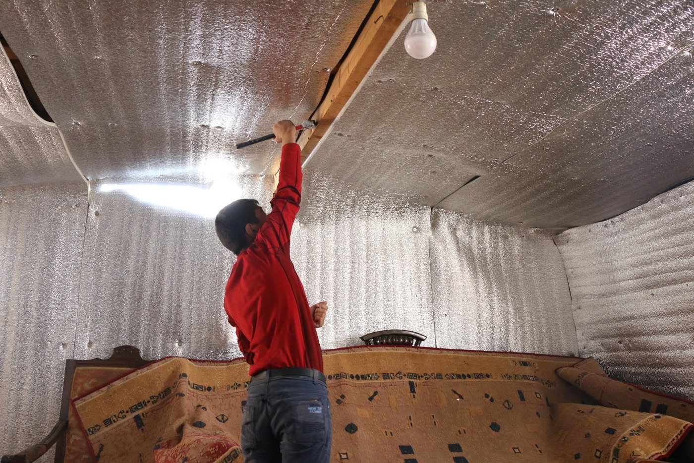 “My husband is trying to repair our shelter with the help of our 10 and 8-year-old sons, Mahmoud and Adnan. They are removing nails, replacing the timber and covering the roof so the tent doesn’t flood anymore. They work as if they were adults,” says Intisar, a 36-year-old Syrian refugee in Arsal.
As harsh weather conditions sweep across Lebanon, thousands of Syrian refugees have been left vulnerable in the hill town of Arsal. The Lebanese government opposes the creation of formal refugee camps, so many refugee families have resorted to living in informal tented settlements.
Photo: Racha el Daoi/NRC