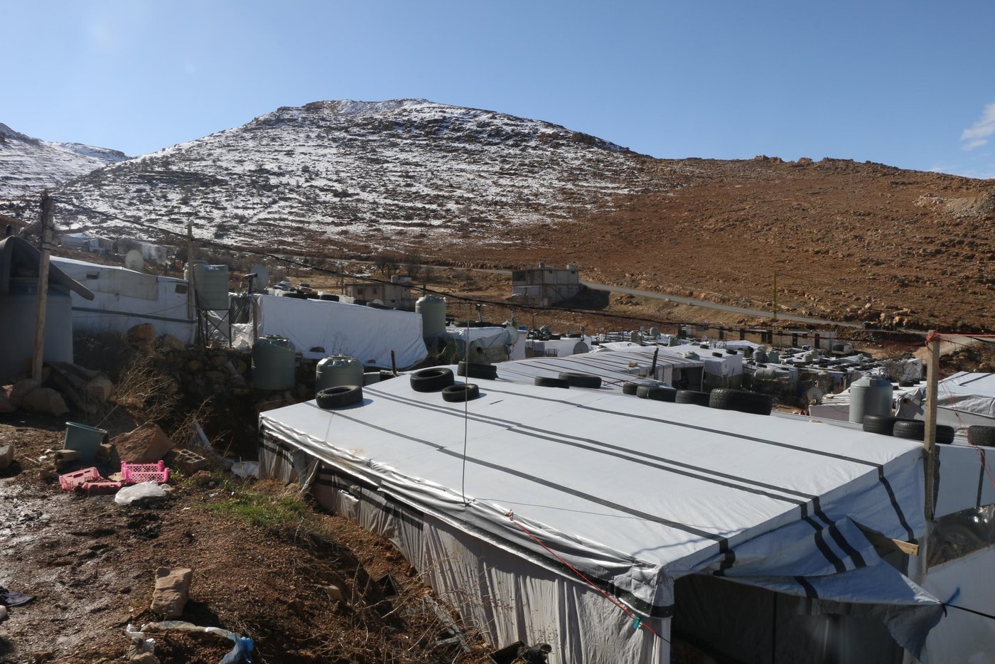 Lebanon has the highest number of refugees per capita in the world, amounting to over a quarter of the country’s total population. This has created a huge strain on its infrastructure and public services.
Under Lebanese law, Syrians and Palestinians are not considered refugees, but “guests” granted temporary hospitality. The Lebanese government opposes the creation of formal camps, and its building codes and policies restrict the construction of permanent shelters. Many concrete homes previously built for refugees have had to be destroyed.
Photo: Racha El Daoi/NRC