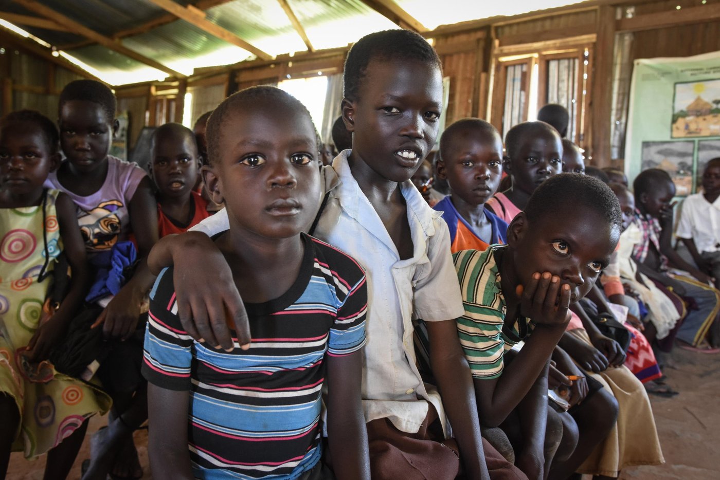 Levi Hakim (in white shirt) has fled from Mukaya and found protection in Yei, where he is attending NRC's Education in Emergencies classes.
"At the time we fled there were a lot of gunshots and we started to run. I was scared. We heard a lot of gunshots. The only thing we could bring was something for cooking and a jerry can. The mattresses and our other belongings were burned. Our house was set on fire.
At the time we ran they had already set the house on fire.
The whole family fled together."
They were two sisters, six brothers, him and his parents.
"We were using a bike. My father was bringing me and a young sister by bike. We fled in the morning and reached here by 3 pm."
"The situation here is okay. School cleans my mind and makes me think that I can be a good person in the future. That is why I want to go to school.
In the future I want to repair vehicles. That is what I want to learn. To repair and to drive.
I am hoping for peace. If there is peace, people will live freely. If there is stability we will go back. If peace is there."
The photo is from St. Thomas primary school in Yei, South Sudan. The school is providing education for children displaced by conflict - who have come to Yei for safety. NRC has built a new school building and latrines, and is running the education program with support from ECHO.
Photo: NRC/Tiril Skarstein