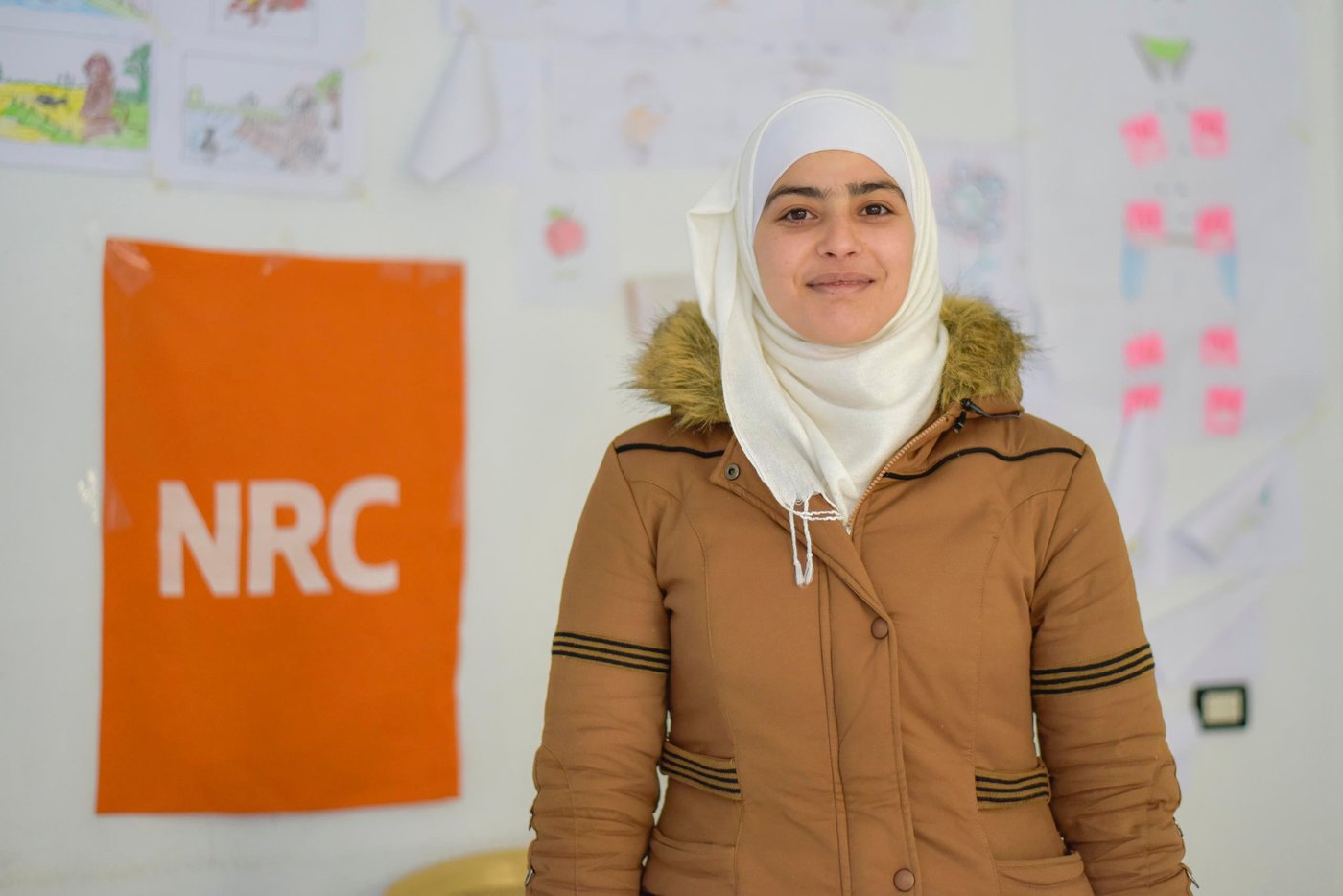 On International Women’s Day, we’re celebrating strong women like Reham from Syria who, despite the many obstacles, continues to fight for her dreams.
“We had to leave everything behind. My father went missing and the area wasn’t safe anymore.” When the crisis broke out in Syria, Reham and her mother had to flee their home. Shortly after, her mother was diagnosed with cancer. Reham was forced to drop out of school and at age 19 she gave birth to her first child, who suffers from a chronic disease.
As a young mother, Reham is determined to complete her education. “I want to become a doctor so that I can treat my son and any child who suffers from illness,” she says.
Reham, now 22, is continuing her studies through NRC’s self-learning programme for youth. “The best part of this programme is that they provide an interactive way to learn – it’s not formal,” she explains.
Being a mother and a student at the same time is no easy task. Reham describes having to juggle these two roles and the big responsibility she shoulders; but nothing can stop her fierce determination. “I wake every day at five in the morning to study and when I come back home, I care for my son.”
Reham has applied to sit her secondary school exams, helping her move closer towards fulfilling her ambitious dreams.
“I encourage and call upon every young girl who left her studies during the crisis to return to school because she can make it!”
Photo: Tareq Mnadili/NRC