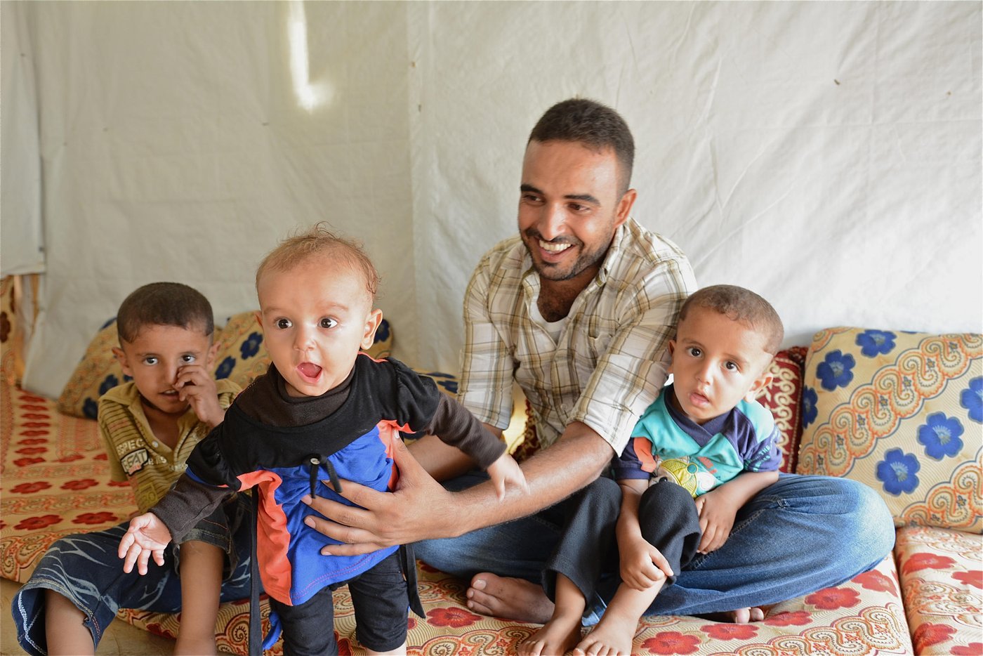 Chebli (26) and his children Younes (4), Tamer (2.5), Sidra (7 months). The family fled Syria two and a half years ago and they are currently living in a tentted settlement in Northern Lebanon. 

Photo: Tiril Skarstein, NRC