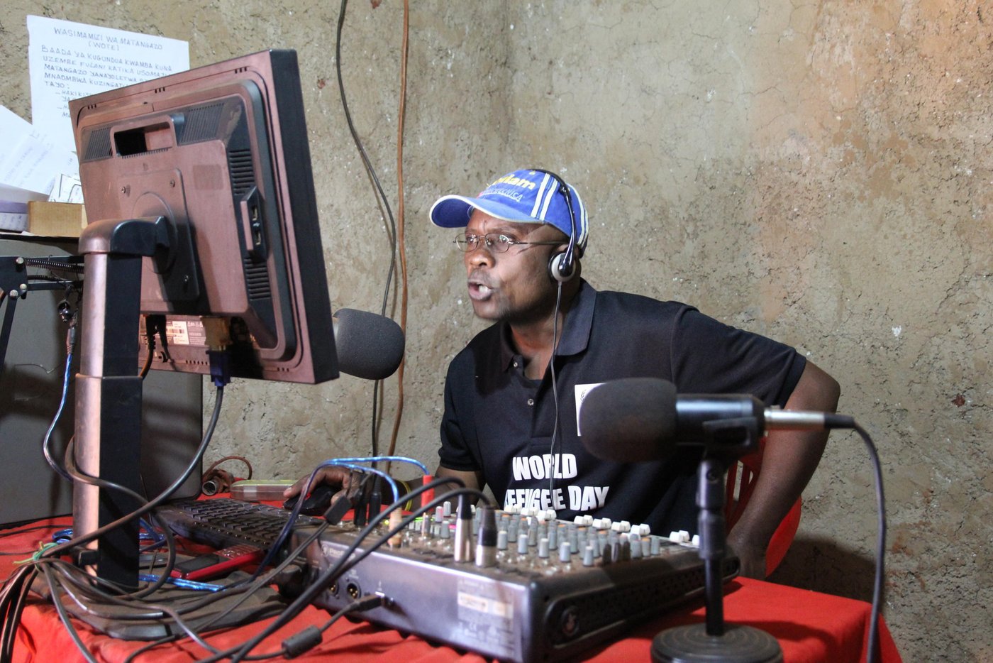 Gabriel is a presenter at Umoja Radio 92.3 FM
He was once a refugee in Mtabira where they established a radio station. But after a very short time, the refugee camp was closed and they were taken back to Burundi. After the recent conflict in Burundi he fled again and arrived in Nyarugusu two years ago. He got another opportunity to work in a community radio station at Radio Umoja. His job entails reading the news, sports, entertainment.
Quotes from Gabriel:
"Yes, truly I am very satisfied to be here at this moment, since this has been a dream for me since my childhood I have always wanted to become a journalist. Therefore, I have benefited from this opportunity to be a journist in this radio station called Radio Umoja. Here we have various programmes that we broadcast."
"We have news bulletins, we also have music programmes, as well as sports. Our main objective is to inform the public about what is happening elsewhere across the world. We have various information sites, for example through the internet. We also listen to various radio channels, the biggest being World Radio. We are also following various media outlets."
"We have various programmes that we transmit. For example we have drama, we have music, and we also have sports to entertain our listeners. Our listeners appreciate our work very much, through what we are doing in terms of transmission of programmes. We also have information that we provide as well.
Being a refugee is very difficult. It is never easy. Therefore, we try to support since being refugees is a forced event. Therefore, we try to do all that we can so as to support. And we hope that one day, peace will return to our country and we shall make the decision to return to our country of origin."
Photo: NRC Ingrid Prestetun