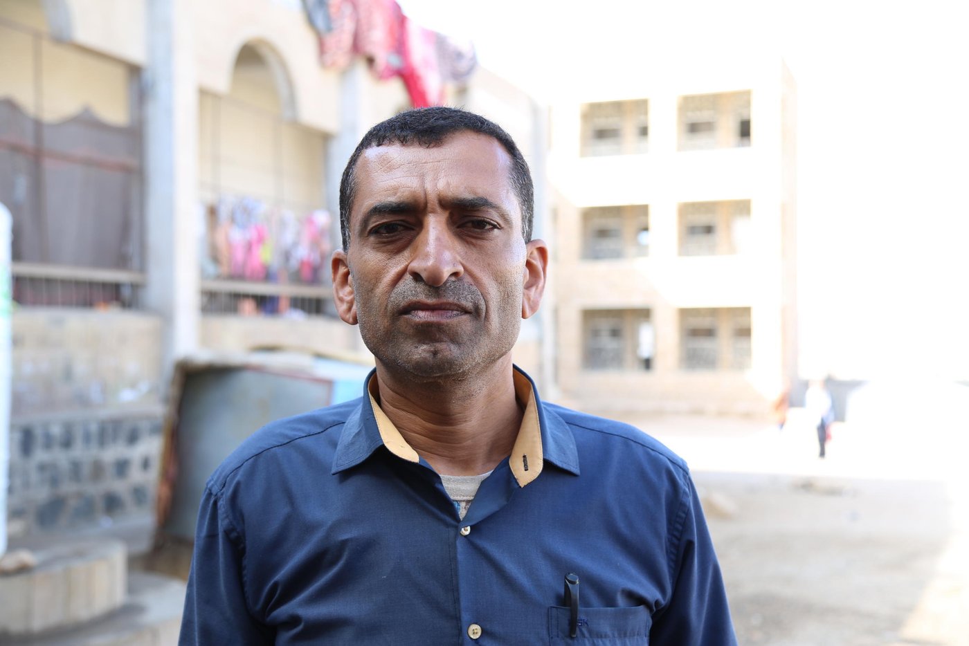 Salah Alwan Al-Asbahi is a history teacher at the school. He confirmed that the residents are the main barrier to resuming the regular educational process in the school.
“We need a compromise that finds an alternative place for the displaced families,” Salah says. “We need this for the educational process to continue in a good way.”
“The displaced families are brothers to us, and they deserve decent life like us, but we don’t want their presence to affect the educational process,” he adds.
There are more than 1,200 students learning in just 11 classrooms in the available school building. Many others have left to attend schools further away.
Salah wants the educational process to continue. He believes that the only way forward is for the authorities to provide a safe alternative for the families living at the school where he works.
Photo: Nasser Abdulkareem/NRC