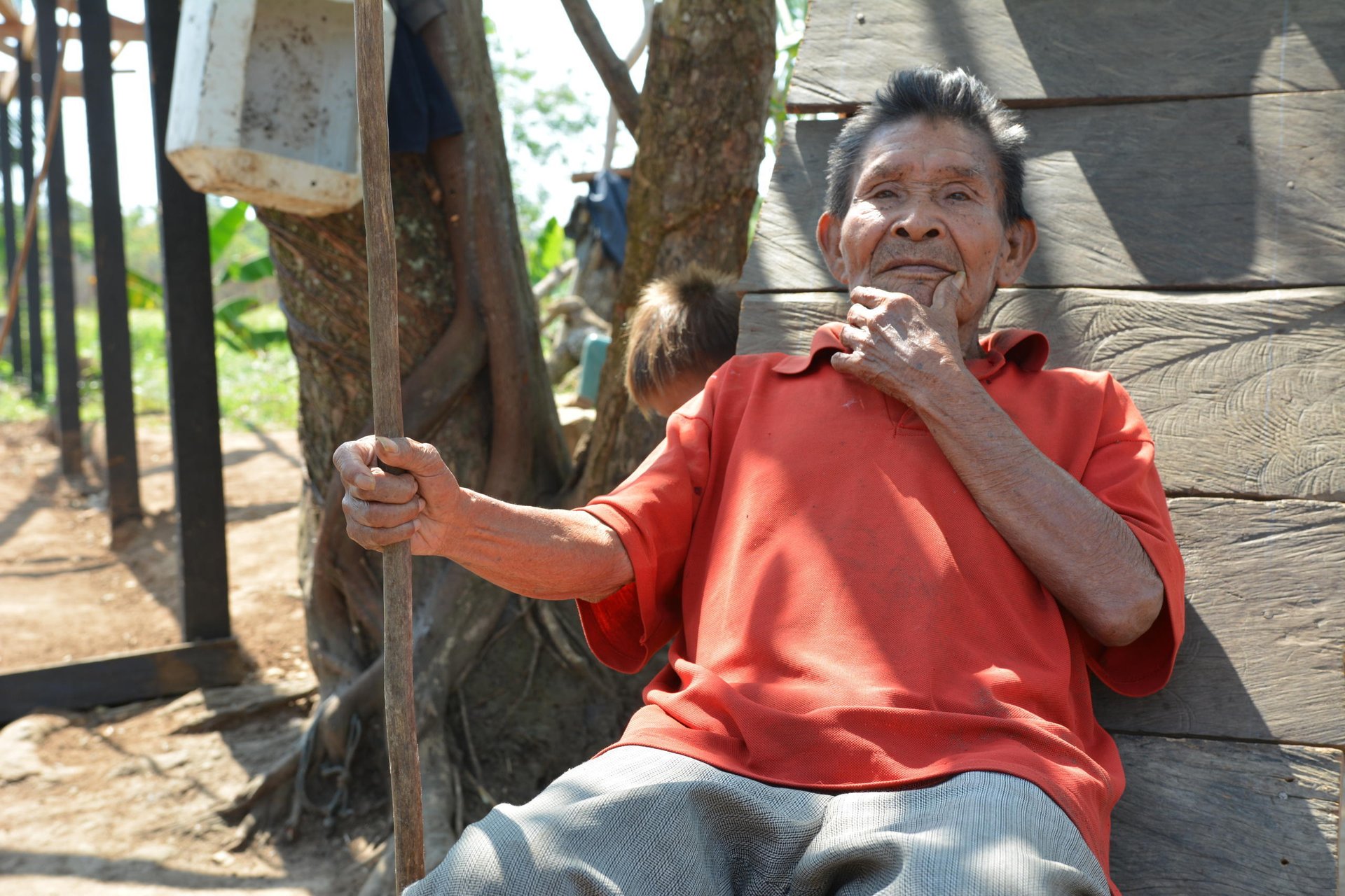 Vicente (76) sits in the sun. He explains the merits of the handmade basket his people have made for generations. It’s his job to teach his great grandson Andreas to make traditional handicrafts.
“All young people must learn,” he says. “They should all learn as I did before.”
But many of the old handicrafts that are traditional to the Jiw are dying out. The community has been uprooted from its ancestral land time and again because of the conflict. With each displacement, a little of their unique culture and traditions are lost.
In 2009, the Government classified the Jiw as one of the country’s 30 endangered tribes.
Forty years displaced
Some of the 17 families in this small community in El Salado have been displaced by violence since 1970.
Vicente, his daughter Luzdary (66) and Andreas are three generations of Jiw that have finally returned to their ancestral lands. They are part of a group that the Norwegian Refugee Council has helped to return to a place they can finally call home.
Traditionally a hunting tribe, Andreas proudly shows off a spear he uses for hunting.
“There are fewer animals nowadays than before though, and the men in the community must walk up to 8 hours when they go to hunt meat to feed the community,” says Andreas.
Andreas wants to work with computers when he finishes school. “People who work on computers make more money,” he laughs.
Vicente recognizes that the numbers of their people are falling. “Some families were as big as 50 people before,” he recalls. “But now are as small as 30. They left for the towns.”
Neglected communities
A peace deal signed in Colombia in 2016 paved the way for the country to rebuild, after the decades-long war.
International organizations are keen to support, and funding is coming in for development projects like strengthening peace. However, small communities like the Jiw who are in humanitarian need have been somewhat neglected.
Building a future
The Norwegian Refugee Council has been working with the Jiw Community in the Guaviare region since September 2015. We are helping to rebuild homes for hundreds of displaceden, women and children returning to their ancestral lands. We provide free legal counseling so that people know their rights on land issues. We also support children to return to school.
Date: February 2017
Photo credit: NRC / Michelle Delaney
Text: michelle.delaney@nrc.no
