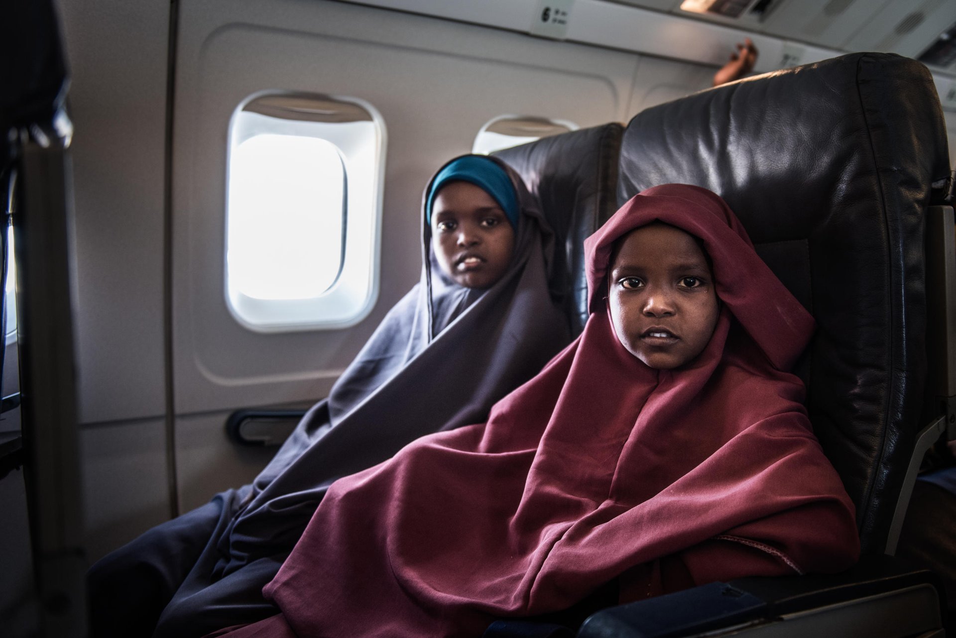 Two Somali sisters (daughters of Halima from story above) sit on board a plane on Dadaab airstrip before it takes off to Mogadishu, Somali.
About 23,000 refugees who have left Dadaab camp this year to return back to Somalia. They are part of a return programme set up by the UN’s refugee agency and the Government of Kenya. NRC is working to ensure that people returning to Somalia are given information about the areas they are going to, and that process is well coordinated and returnees are protected.
Date: September 2016
Photo credit: NRC/ Fredrik Lerneryd