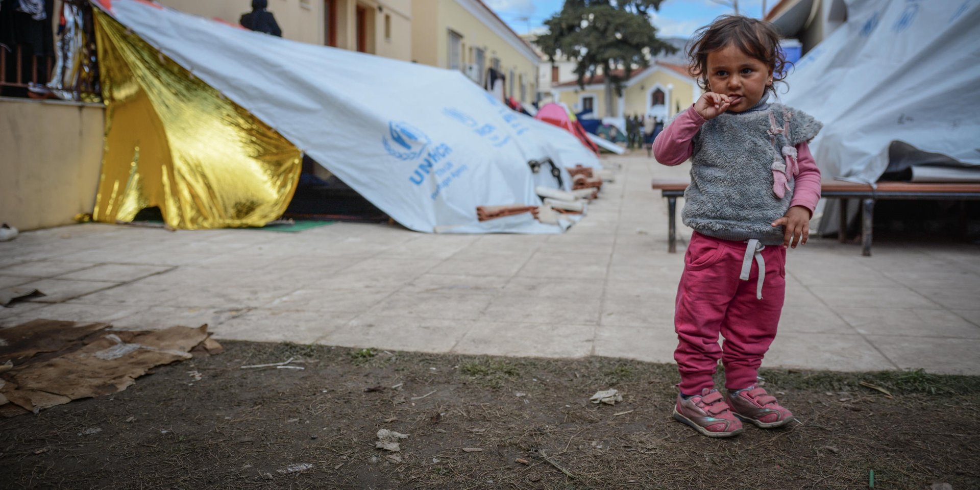 Chios April 2016: Asinat (2) at Depethe camp at Chios, Greece (open facility). Photo: Tiril Skarstein, NRC.
Interview with her father Jamal - fleeing with his wife and their child Asinat (2).
Planes were bombing our neighbourhood. One bomb hit our home and I had an injury in the stomach and I was taken to hospital were I had an operation. My wife was also hit in her shoulder. But luckily is was able to shield Asinat (2). It was during the previous Ramadan. We decided we need to get to safety in Europe. The travel has been very difficult, both to cross from Syria to Turkey and across the sea to get to Greece. We have been close to death.
We escaped form the war, but here in Greece we were taken to a detention center. We have no rights here. We escaped the war, but for what? I have friend in Oslo and other parts of Europe and they tell me that their rights are respected - but here we have no rights and there´s no humanity.
I am afraid we will be sent back to Turkey. There is no life for us there.
In Syria we would die quickly, here we are dying slowly. In Syria we would be killed in the war, here the despair is strangling us.
See also video interview.