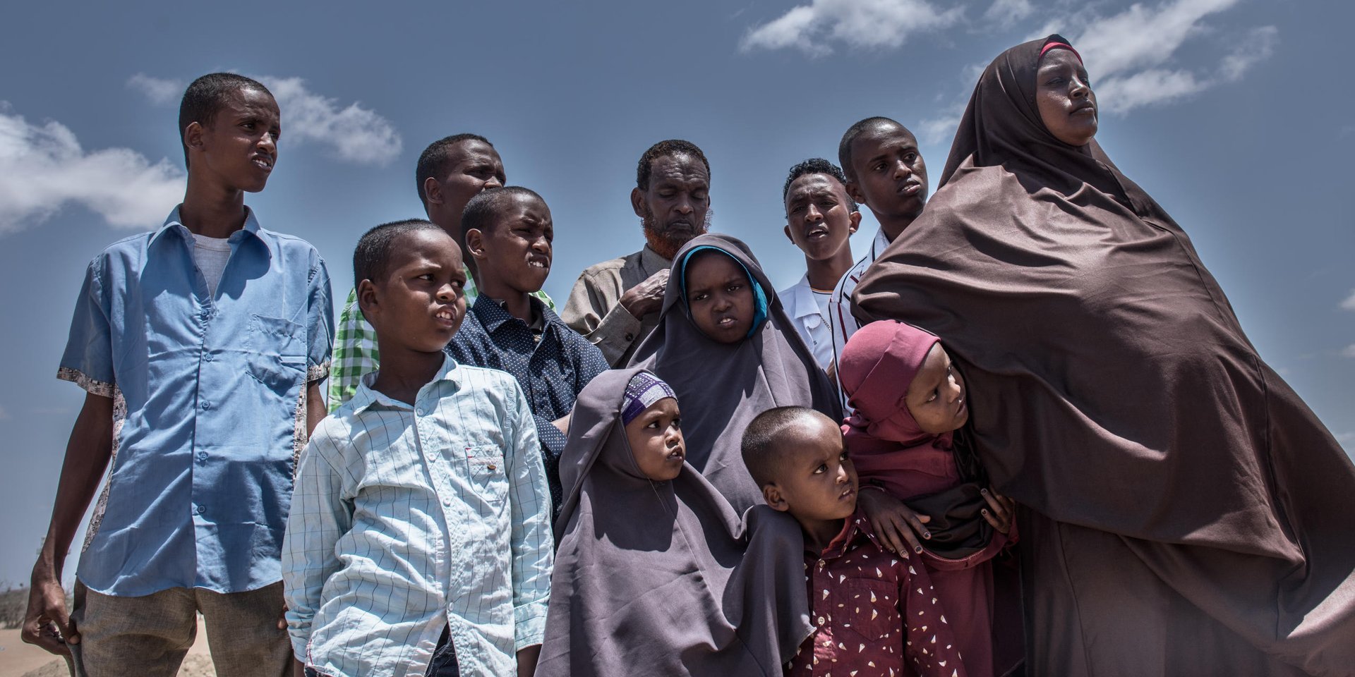 Today, Halima (32) (right) and her husband Abdinajir (50) (middle back row) are returning to Mogadishu with their big family of ten children. They have been living in Kenya’s Somali refugee camp for the past 6 years, after fleeing Somalia’s capital in 2010.
“We are happy about our time in Kenya. But all our friends in Dadaab camp have left and gone back,” said Halima. “It’s a sign to us that it is time to leave.”
The UN refugee agency is helping the family return by plane to Somalia. NRC is providing information to refugees who decide to return, about conditions on the ground.
Mogadishu is still fragile and it will take time to re-establish for Halima’s family to set up a life there. But Halima is hopeful: “Yesterday in the camp I had nothing. Now I have a small aid package to help us return. I will make a life for myself and my family in Mogadishu. I am a confident woman and strong mother.”
Halima is pregnant with their 11th child. We wish her and the family the best of luck with their new lives.
Halima is one of about 23,000 refugees who have left Dadaab camp this year to return back to Somalia. They are part of a return programme set up by the UN’s refugee agency and the Government of Kenya. NRC is working to ensure that people returning to Somalia are given information about the areas they are going to, and that process is well coordinated and returnees are protected.
….
For Facebook:
Today we met Halima on the dusty airstrip of Kenya’s Dadaab refugee camp. She and her husband Abdinajir were returning to Somalia with their 10 children, after six years living as refugees. They flew with 40 other families who are going home to build new lives in Mogadishu. Halima is expecting her 11th child soon. We wish her good luck!
Date: September 2016
Photo credit: NRC/ Fredrik Lerneryd