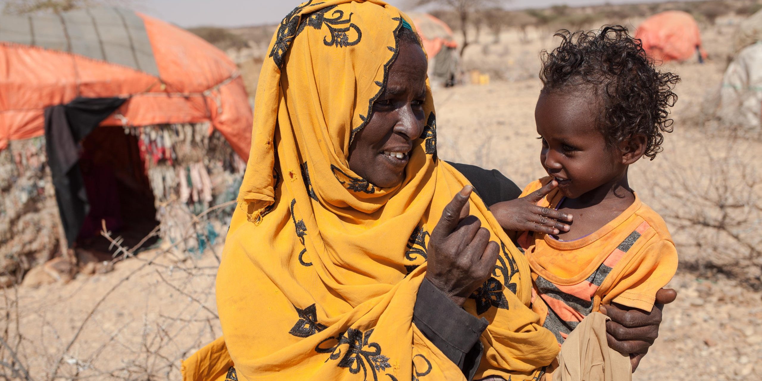“Everything got lost during the drought. No more pasture, no more animals, no more food” deplores Halwo Mire Abdiwahad, 60 years old. Six months ago, she walked two days to get near to the small water point and village of Shimbirale with her family of 11 children and grand-children. There, they lve in a small tent made of plastic and fabric.
Before the drought, they used to eat three meals a day, made of meat, milk and butter. But they lost all of their 100 sheep and goats, and 5 camels. In Shimbirale, with the Norwegian Refugee Council's three money transfers she received, she was able to cook twice a day. Their meals where Somali pancakes, rice and tea. “Without this help, I cannot imagine in what situation we would be now. I cannot guarantee we would all be alive today” she says to Nasra Mohamed Shire, 23, food security assistant with the Norwegian Refugee Council since 2016.
Now that the monthly help has ended, her family only eats small portions of rice, once a day.
When they arrived in Shimbirale, the Norwegian Refugee Council saw no other humanitarian organization working, and huge needs. Three people had just died on the day they registered the displaced pastors, and many were very sick. They gave twice Unconditional Money Transfers of 150$ to 100 households, and provided water in this camp of 300 households (approximately 1800 people).
Somalia is experiencing its worst drought in 20 years, following two consecutive seasons of poor rainfall. People are dying of malnutrition. In the worst affected areas, we have seen crops wiped out, livestock killed, and families forced to sell their belongings for food.
Photo credit: Norwegian Refugee Council / Adrienne Surprenant
Date: April, 2017