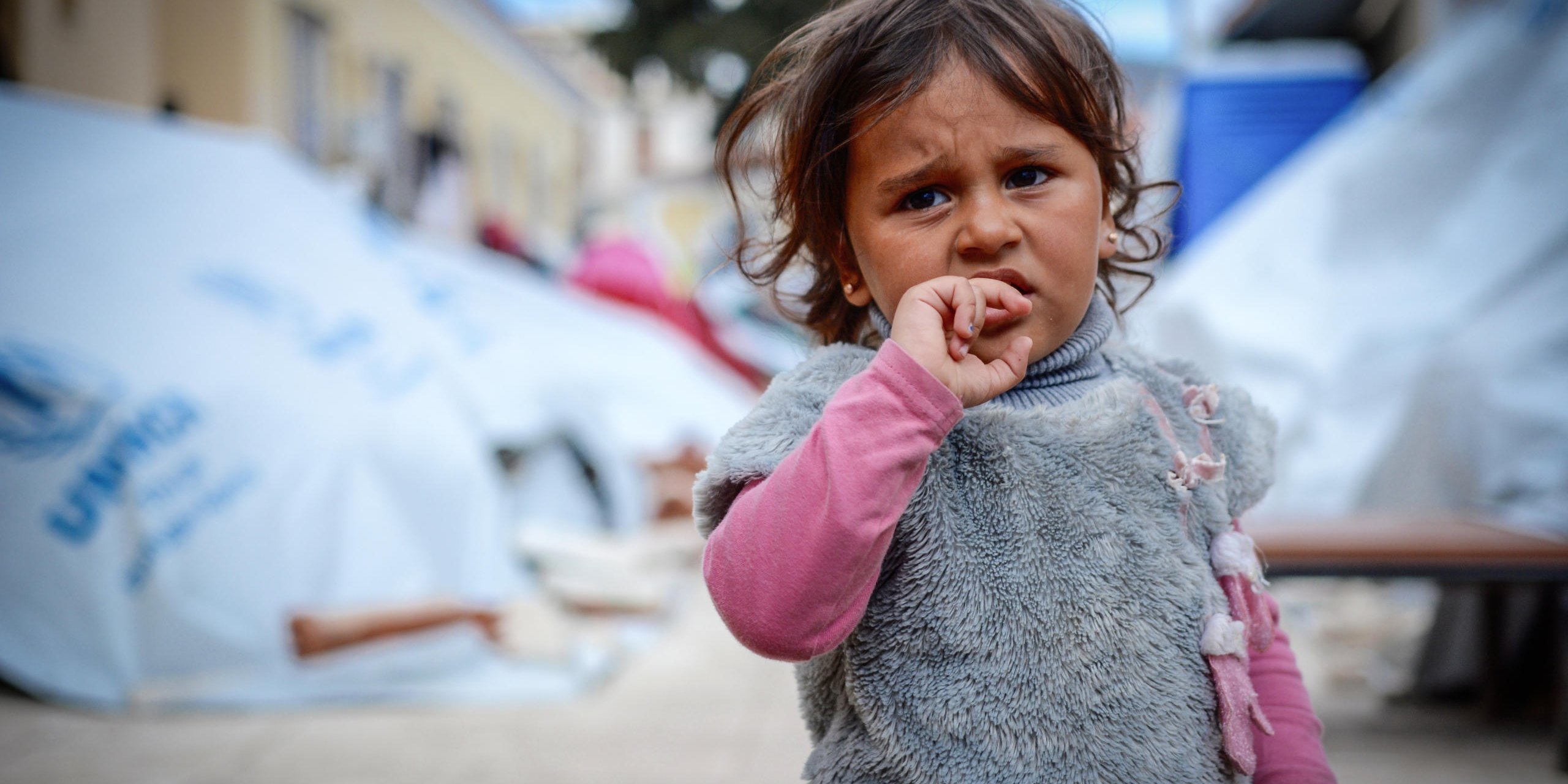 Chios April 2016: Asinat (2) at Depethe camp at Chios, Greece (open facility). Photo: Tiril Skarstein, NRC.
Interview with her father Jamal - fleeing with his wife and their child Asinat (2).
Planes were bombing our neighbourhood. One bomb hit our home and I had an injury in the stomach and I was taken to hospital were I had an operation. My wife was also hit in her shoulder. But luckily is was able to shield Asinat (2). It was during the previous Ramadan. We decided we need to get to safety in Europe. The travel has been very difficult, both to cross from Syria to Turkey and across the sea to get to Greece. We have been close to death.
We escaped form the war, but here in Greece we were taken to a detention center. We have no rights here. We escaped the war, but for what? I have friend in Oslo and other parts of Europe and they tell me that their rights are respected - but here we have no rights and there´s no humanity.
I am afraid we will be sent back to Turkey. There is no life for us there.
In Syria we would die quickly, here we are dying slowly. In Syria we would be killed in the war, here the despair is strangling us.
See also video interview.