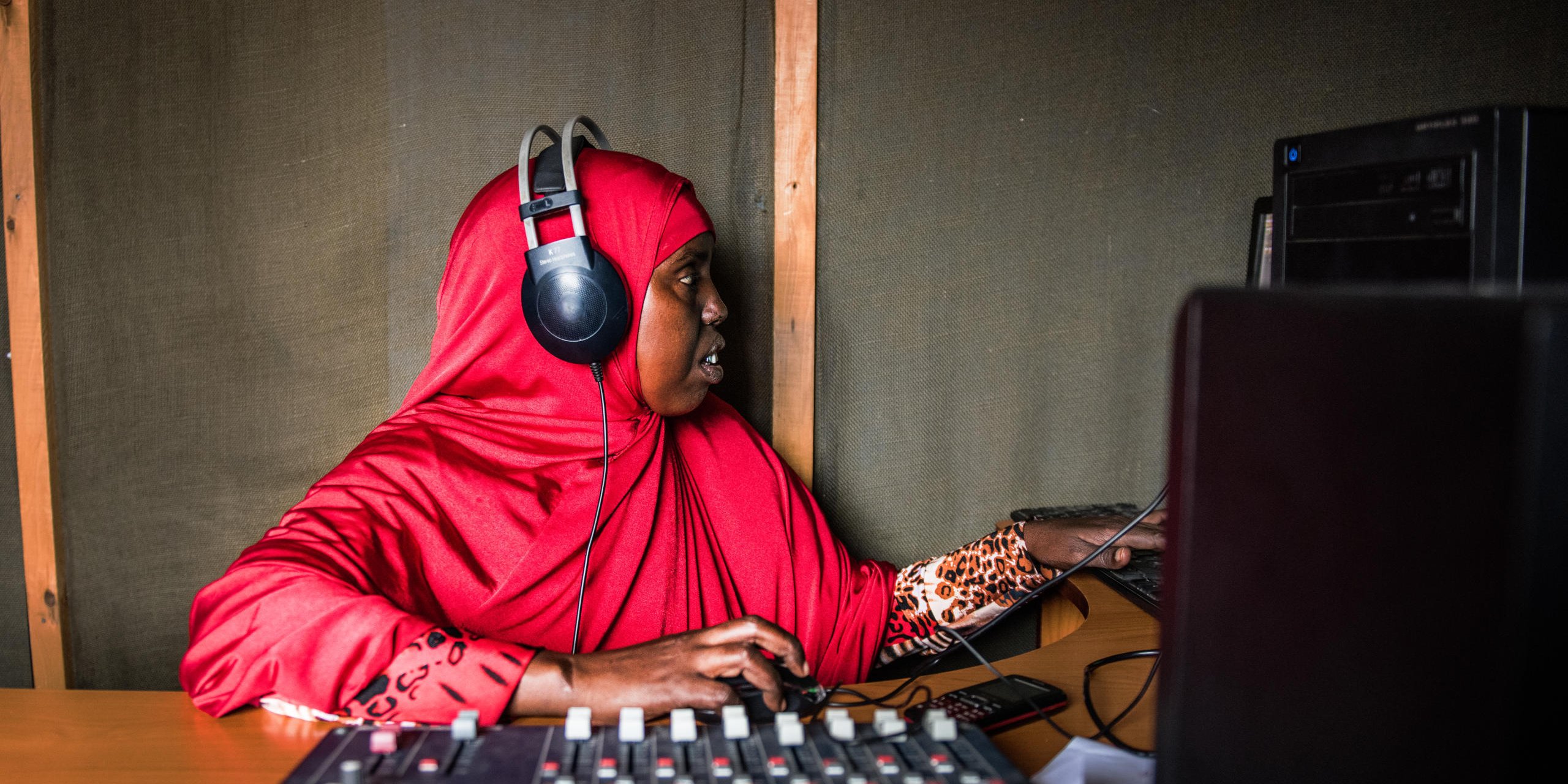 “I’m a Somali journalist. One day I was reporting on a Government bombardment in a town that killed some Al Shabaab fighters. That evening Al Shabaab called me and offered me money to stop reporting. I told them I am a journalist and I work for the people. The next day I reported the news again. That night they came to my home. I escaped to my aunt’s house. The following day I fled to Kenya with my three children.
Now we live in Dadaab refugee camp near Kenya’s Somali border. I work as a reporter for Radio Gargar. It’s the only radio station in the camp covering humanitarian issues. I like reporting on issues that affect women. One day I would like to return to Somalia. But for now it’s not safe for journalists, so I cannot go home.”
Mano (27) is enrolled in NRC’s journalist training school in Dadaab refugee camp, where she is studying as a field reporter and radio presenter.
Radio Gargar was set up as part of NRC’s youth education programme. It is a one-year informal education programme designed to support young people affected by conflict, who have a lack of opportunities or missed out on school. Through the programme, youths acquire a marketable skill to increase their chances for finding employment. It includes crafts such as tailoring, journalism, hairdressing and welding.
Date: September 2016
Photo credit: NRC/ Fredrik Lerneryd