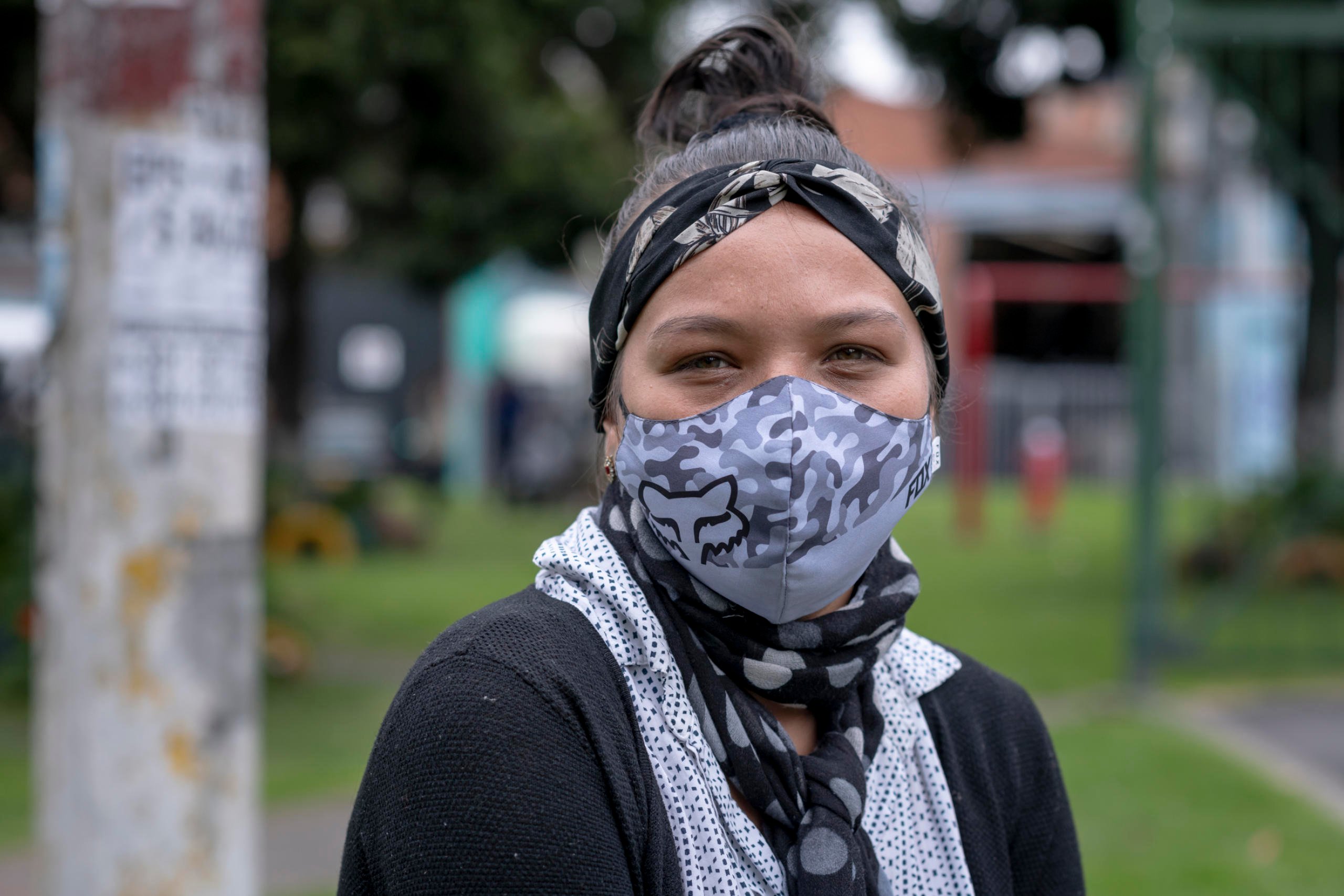 June 25, 2020. Bogota, Colombia: Kendry Castro (23) is receiving the cash aid in the form of a card given to her by a worker from the NRC team after checking her documents. She has two children of one and three years. She came to Bogotá with them from Merida 6 months after her husband when he sent her the money for the trip and she finished her fifth grade of school. She had the dream of studying medicine but she had to leave it and go to her husband. In Merida, her husband had a motorcycle workshop. In Bogotá, he found a job in a fruit shop in the market place. But with the virus, he lost his job and now, he's out on the street looking for trash to sell for recycling. At this time, because the school is close, Kendry stays with her two children, she can’t work. Apart from the market given by the kindergarten, this is the first time they receive help, in 3 years of being in the country. "The other day at one point, I started crying, because I wanted to leave. I called my mother in Venezuela, I wanted to go, I did not want to be here. And she answered: "No! don't come! Look at the problems! Think of the children!" . 
If she has to say something to the world about her life as a refugee: "It's hard. It's both sad and humiliating. Since I've been in Bogota, there are people who insult you. For being Venezuelan, they insult you. (...) There are many of us who wouldn't want this to happen to us. Because it's hard to come from a place where you are loved and cherished, to a place where you are humiliated, discriminated against, looked down on."
Her two children were born in Colombia, they are nationalized. And her husband is also Colombian: his parents were displaced by the internal war in Colombia and found refuge in Venezuela. Today, her grandmother has to return to Colombia. Kendry says, "My children's grandmother is Colombian. And she cries, and she says she wants to go to Venezuela, where she has her car, her house, her farm. Here, no. Here, she doesn't have it now."  Credit: Nadège Mazars for NRC