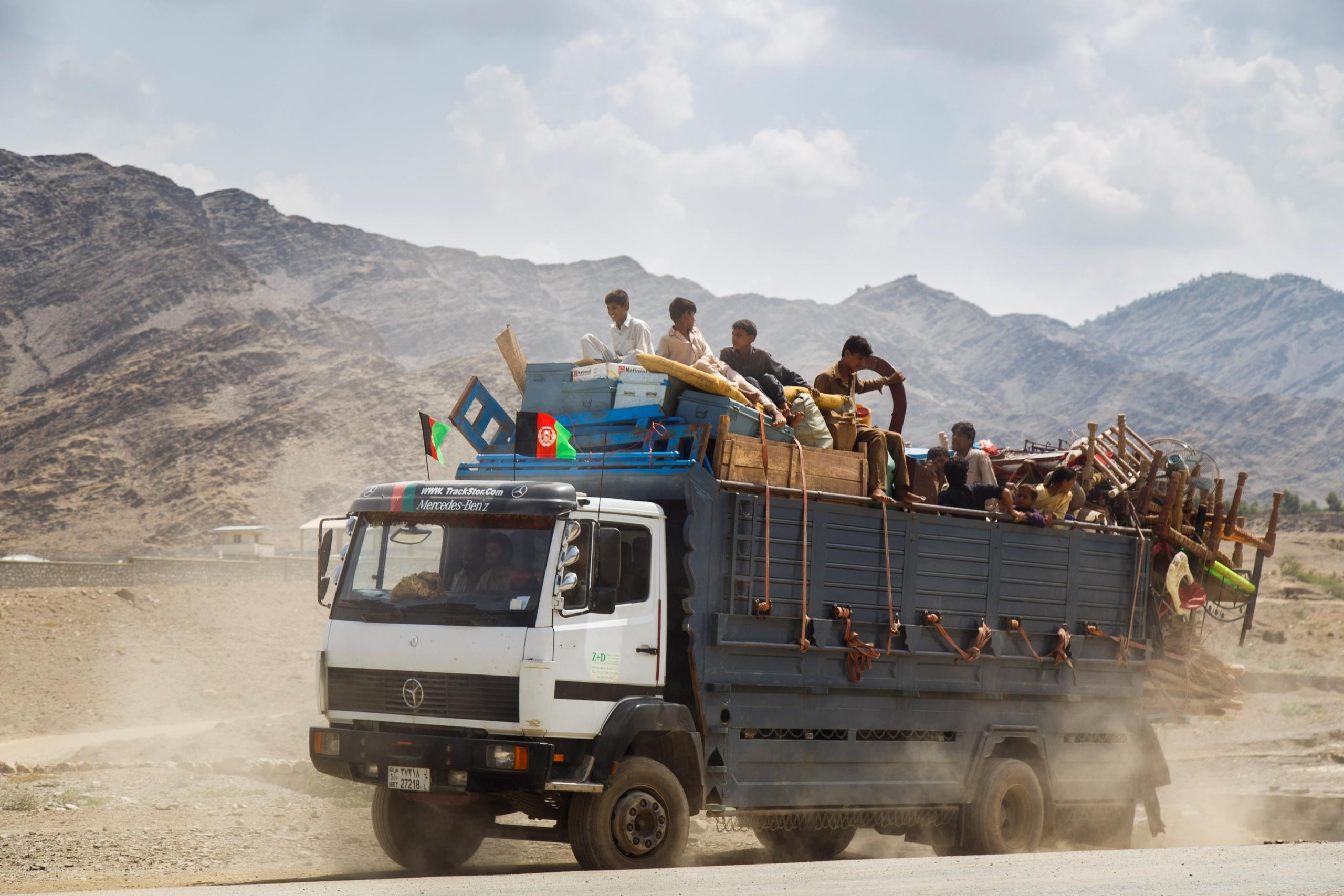 An undocumented returnee family bundles children and belongings on the back of a truck returning to Afghanistan. (Photo: NRC/Jim Huylebroek)