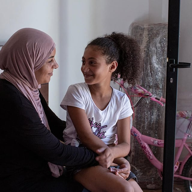 Fatima Bashir, 9, sits with her mother Sarah Mohammad Omara Shehadeh, 42, in her family’s apartment in Karantina, Beirut, Lebanon, on October 23, 2020.