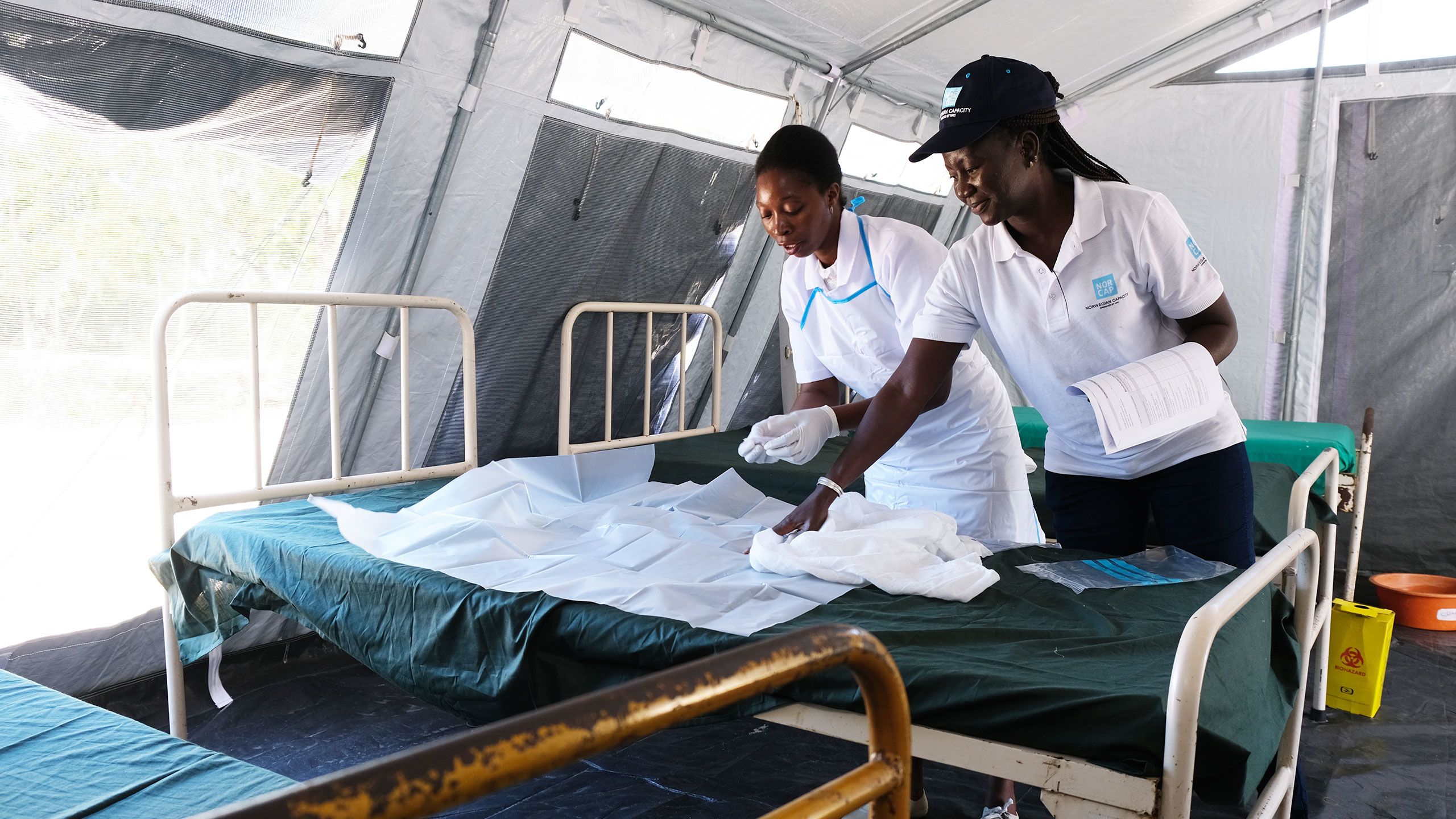 NORCAP expert Sabine Nana together with Suiana, who is training to become a midwife at a health clinic in Macharote in Mozambique that was destroyed during cyclone Idai.