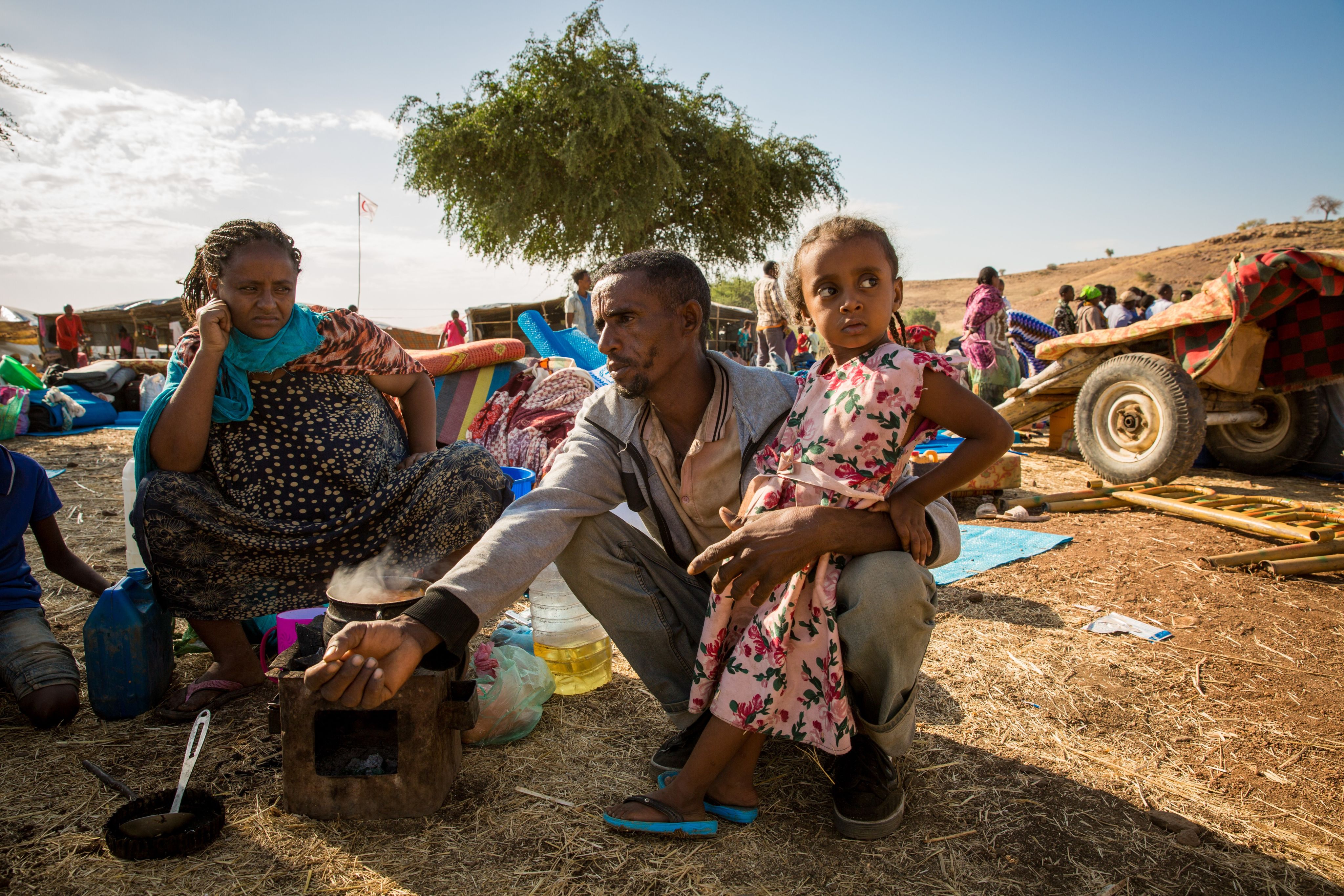 A small family that has recently arrived at a refugee camp in Sudan.