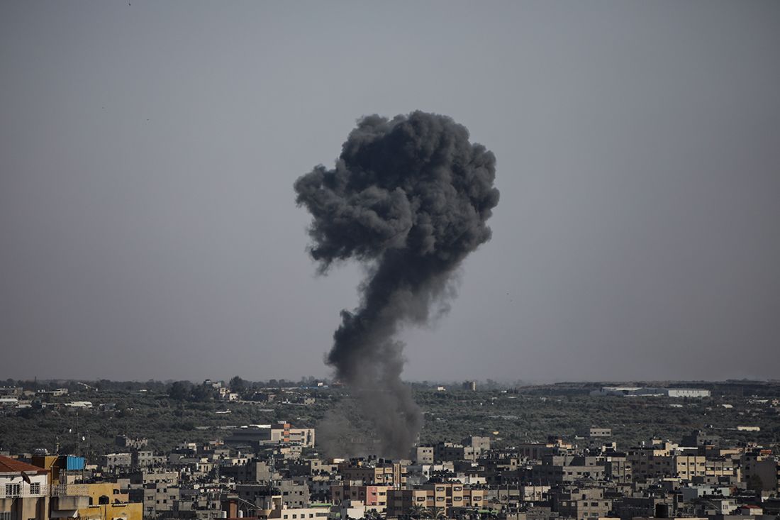 A bomb hits a house in Gaza. Black smoke rise.